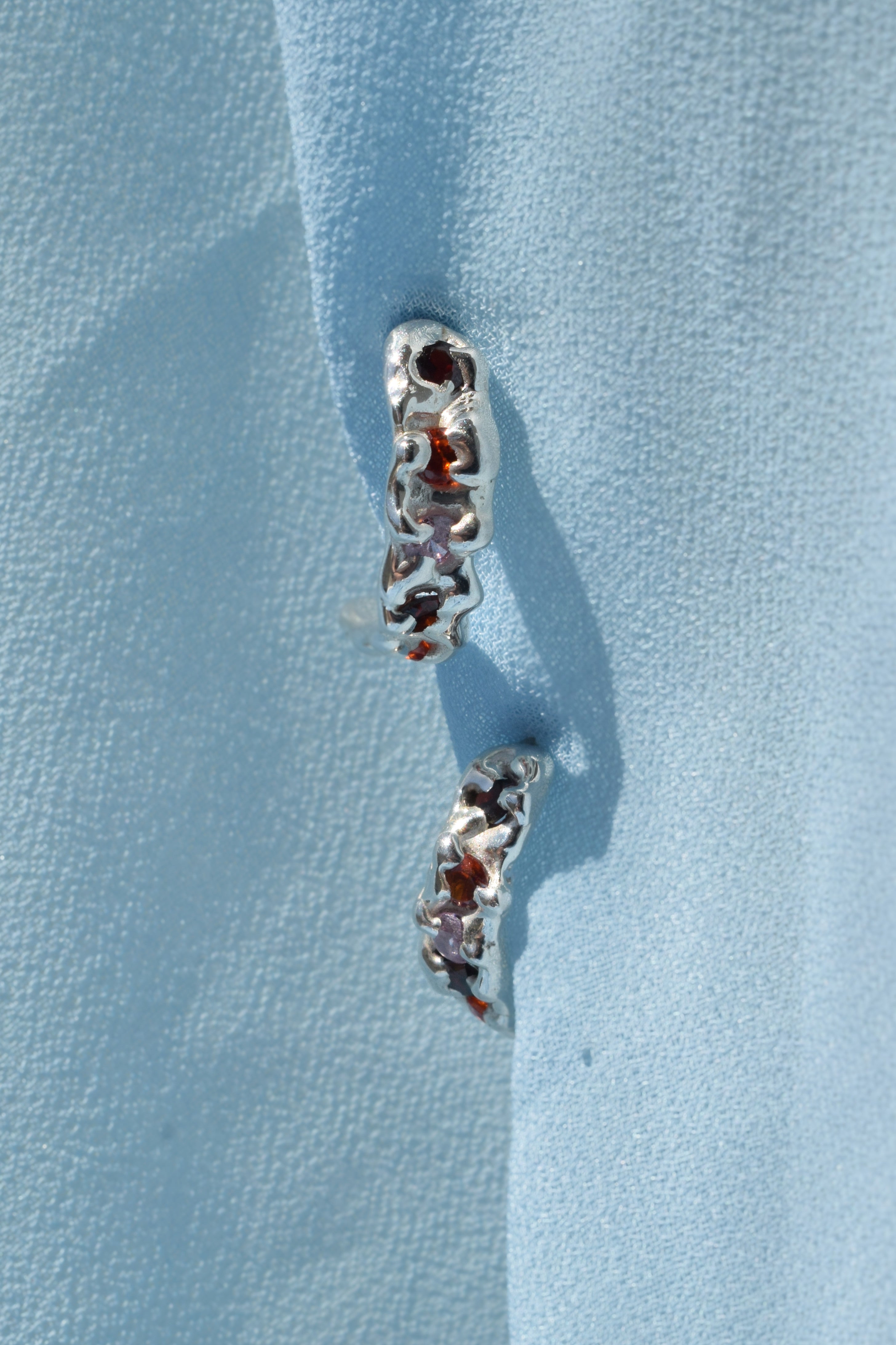 Sterling silver molten textured hoop earrings with red, orange & pink cz crystals