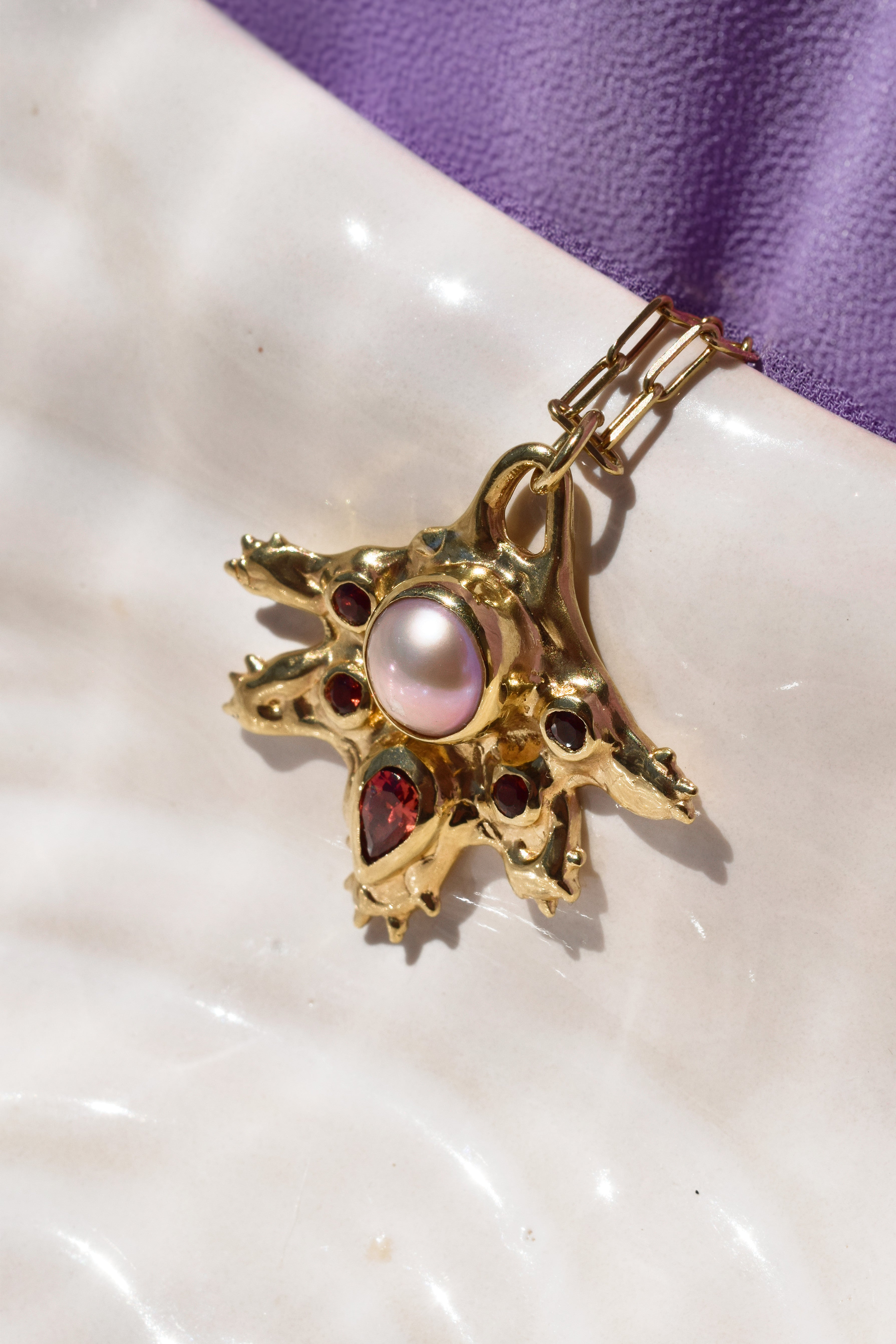 Coral inspired gold plated talisman necklace with pink pearl and red garnets