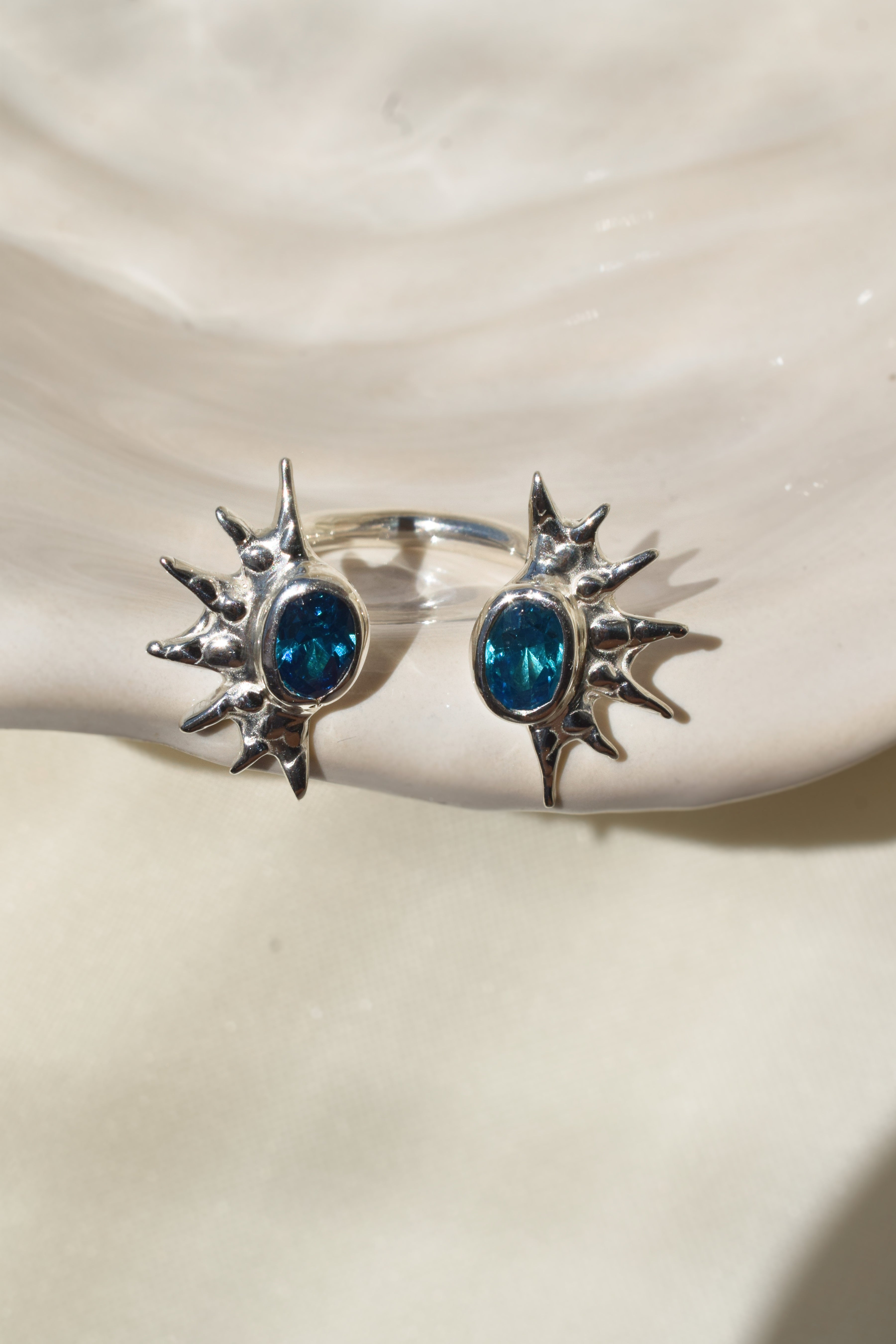 Double sunburst cuff ring with blue cz crystals