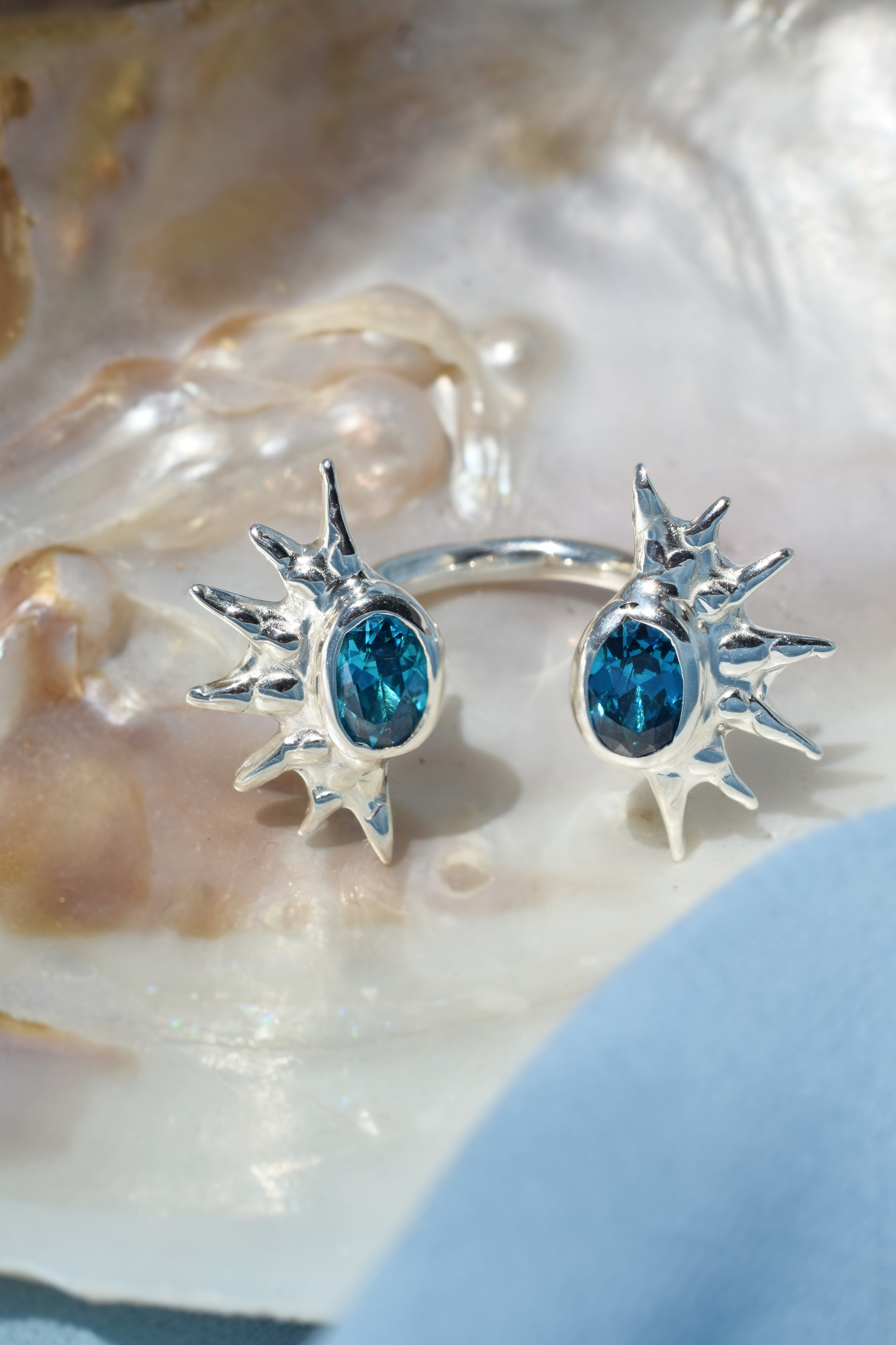 Double sunburst cuff ring with blue cz crystals