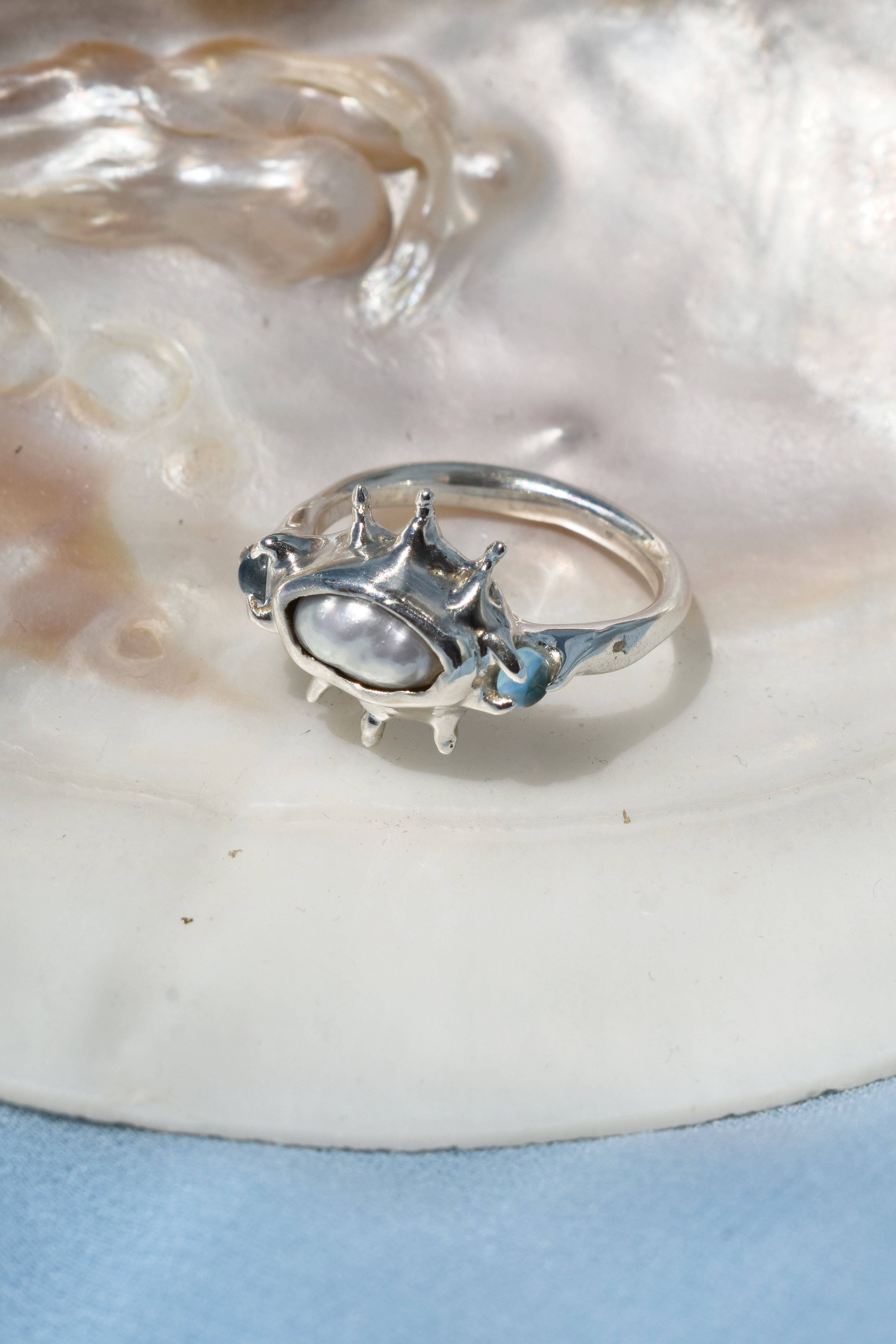 Ocean inspired ring with raw irregular pearl and blue topaz