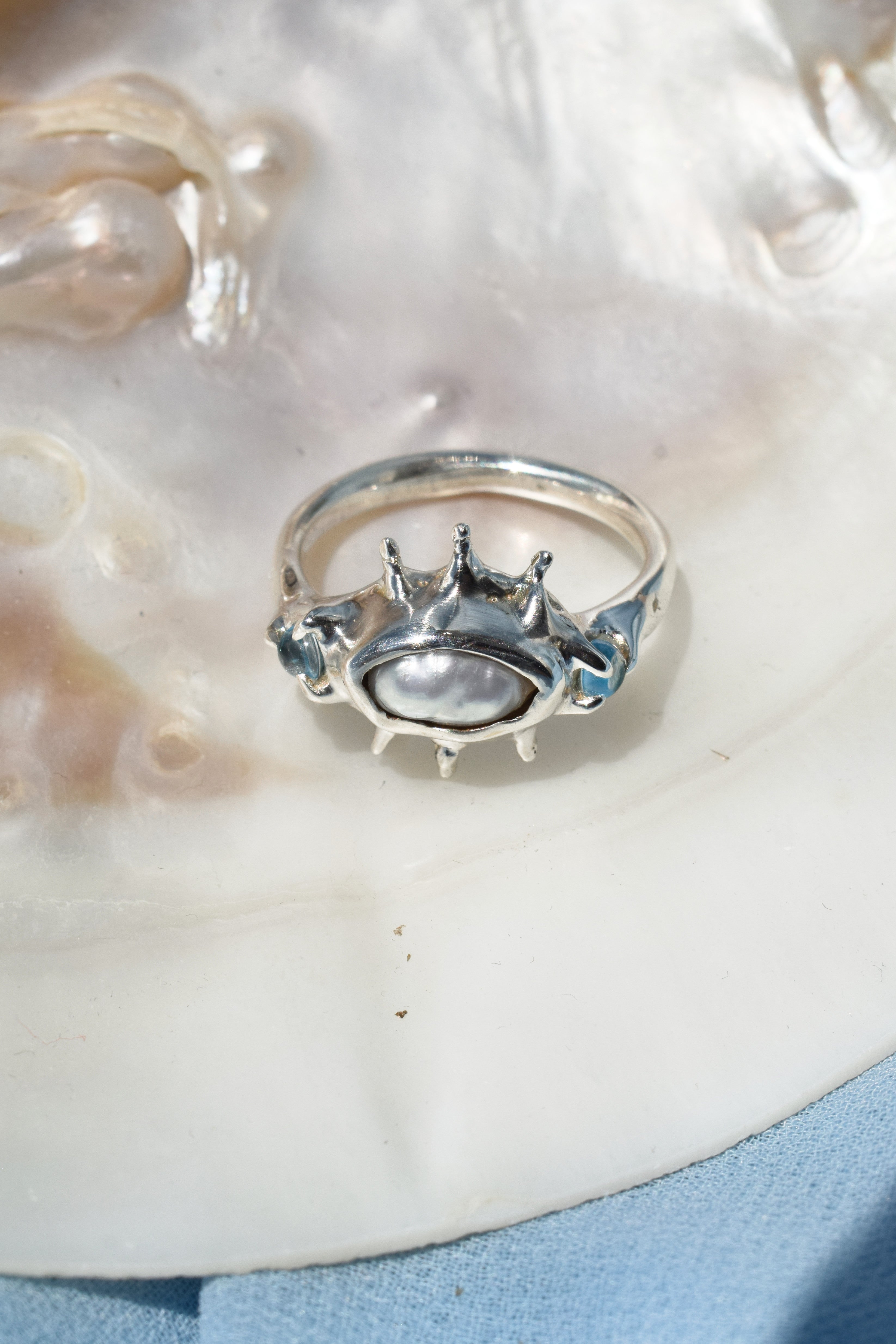 Ocean inspired ring with raw irregular pearl and blue topaz