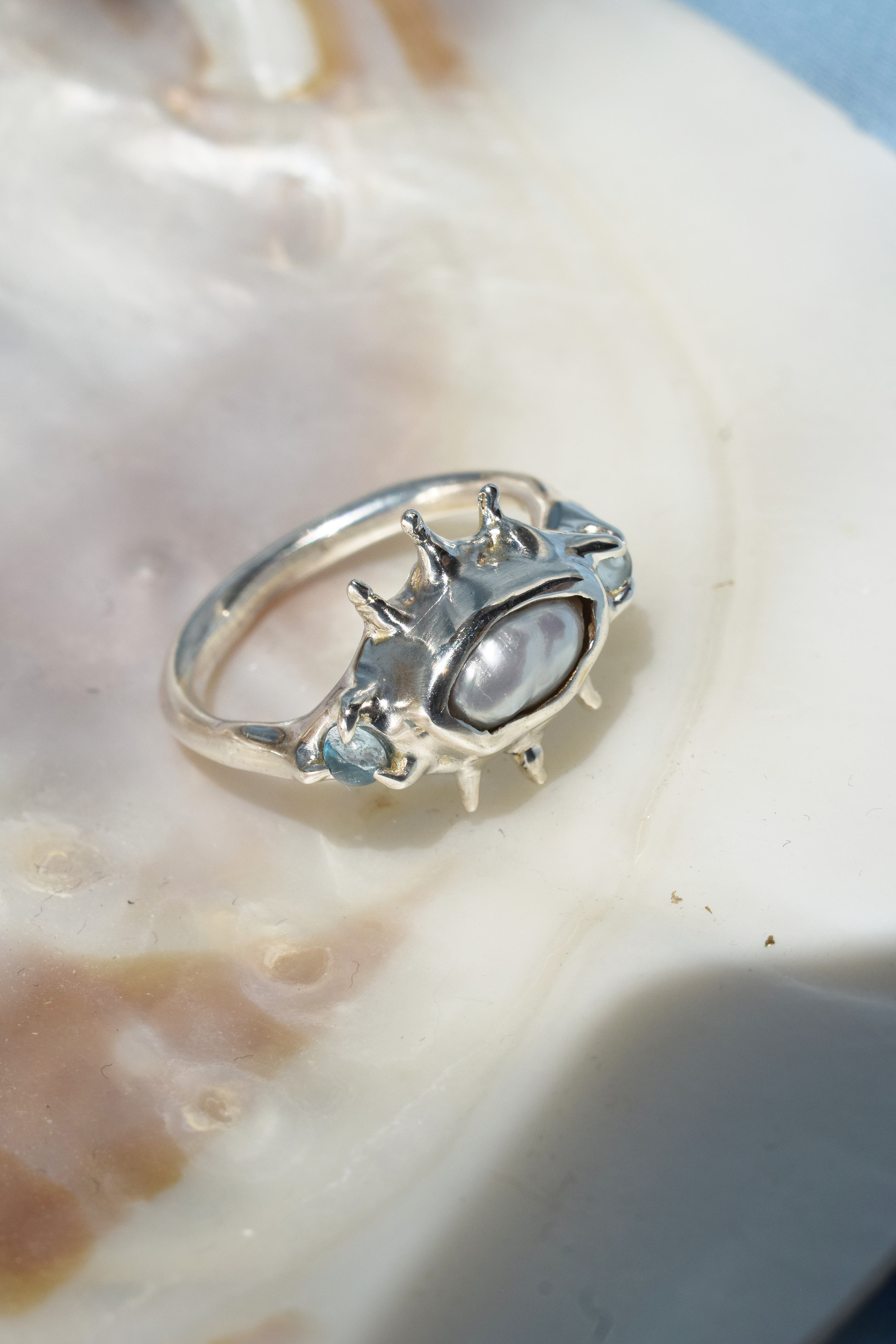 Ocean inspired ring with raw irregular pearl and blue topaz