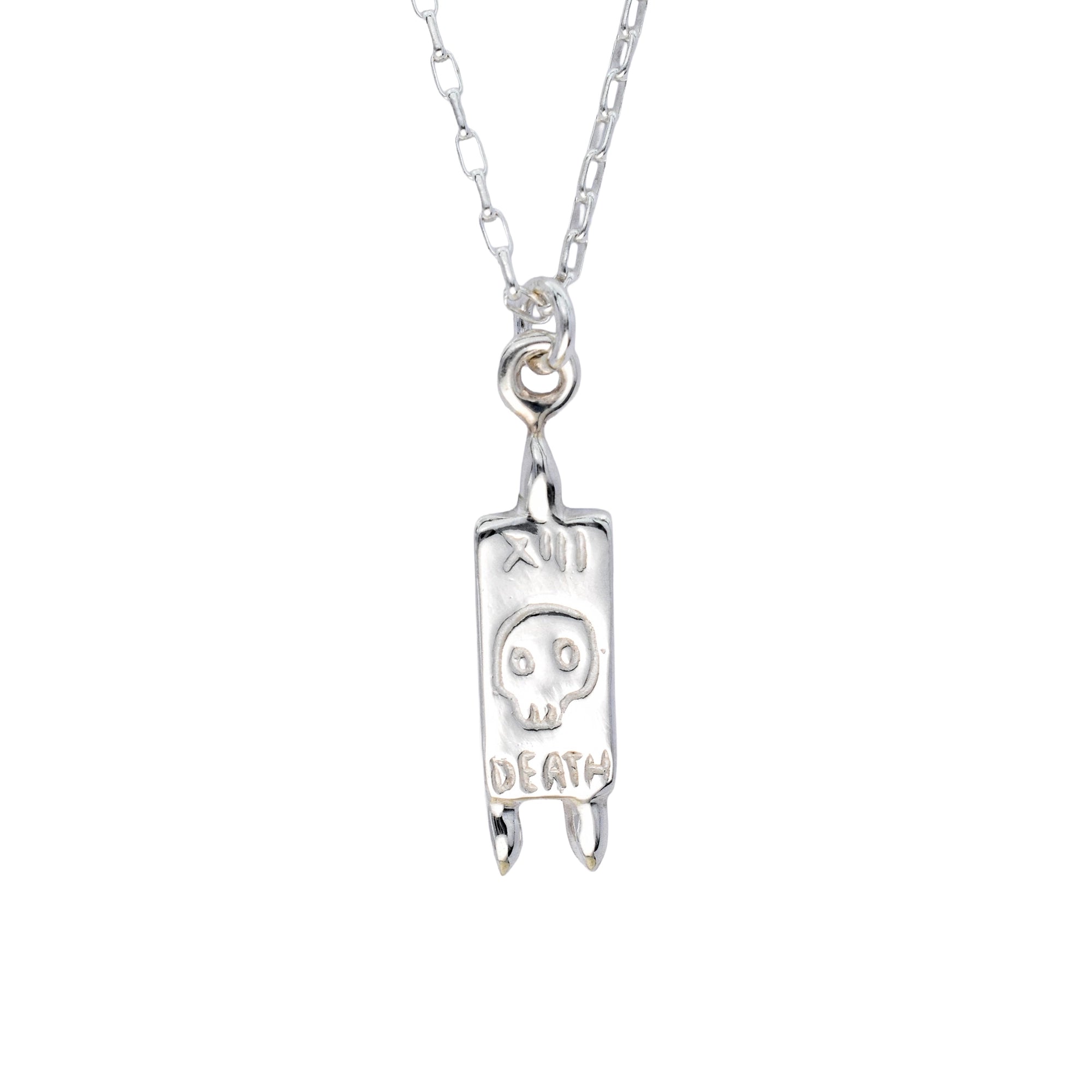 A silver pendant necklace featuring a rectangular tombstone charm engraved with a skull, Roman numeral XIII, and the word 'DEATH', suspended from a silver link chain against a plain white background.