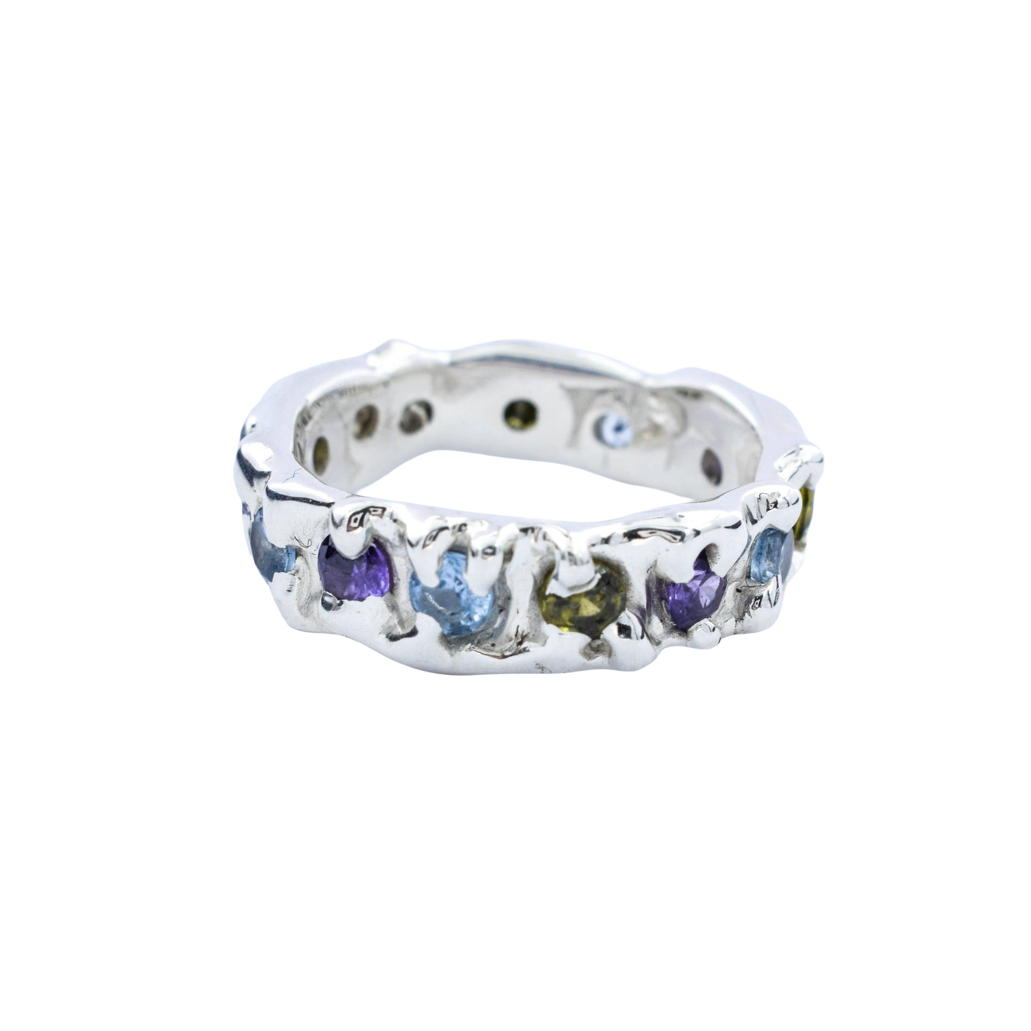 A sterling silver eternity ring featuring multiple small, colorful gemstones