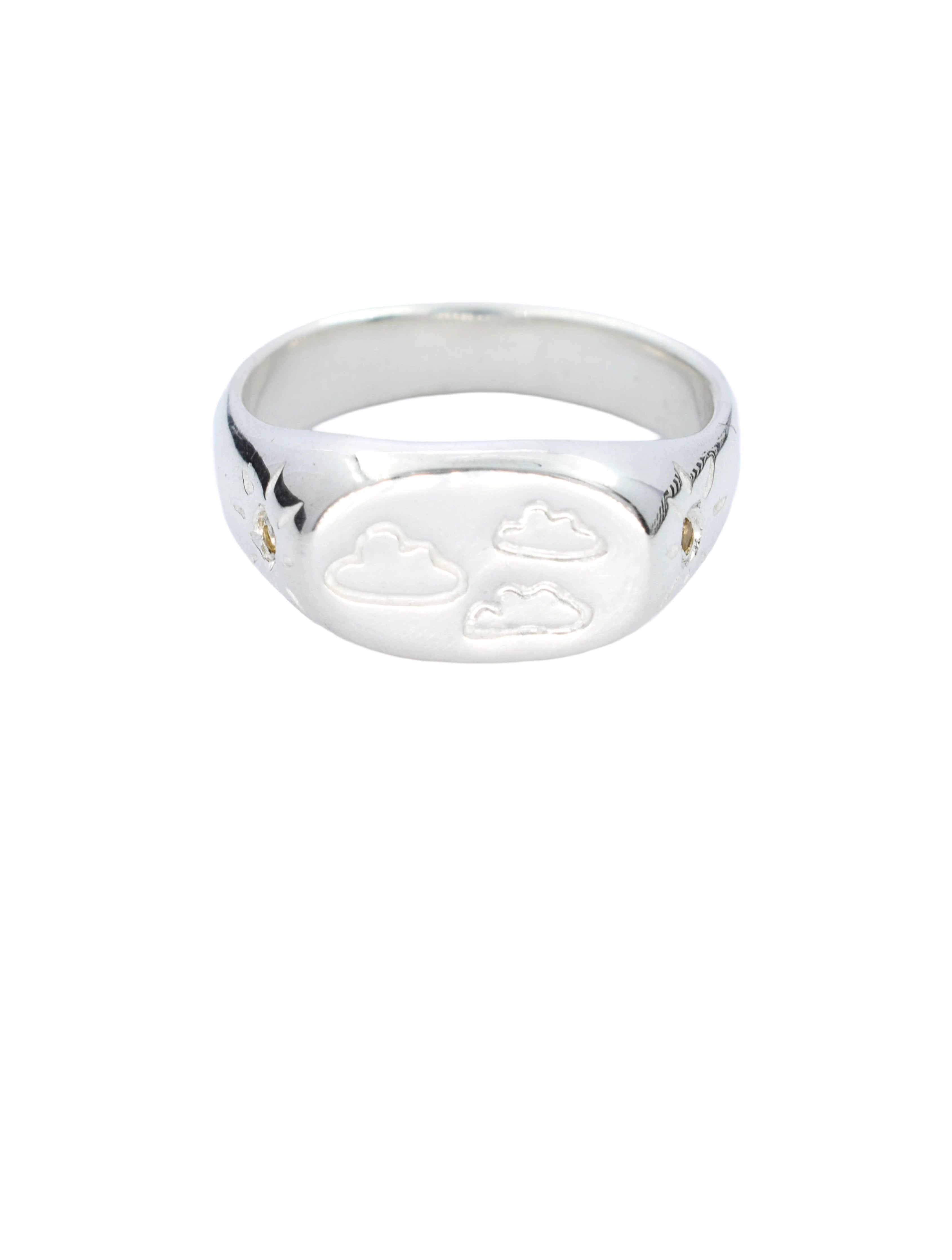 Silver ring with heart designs on a white background