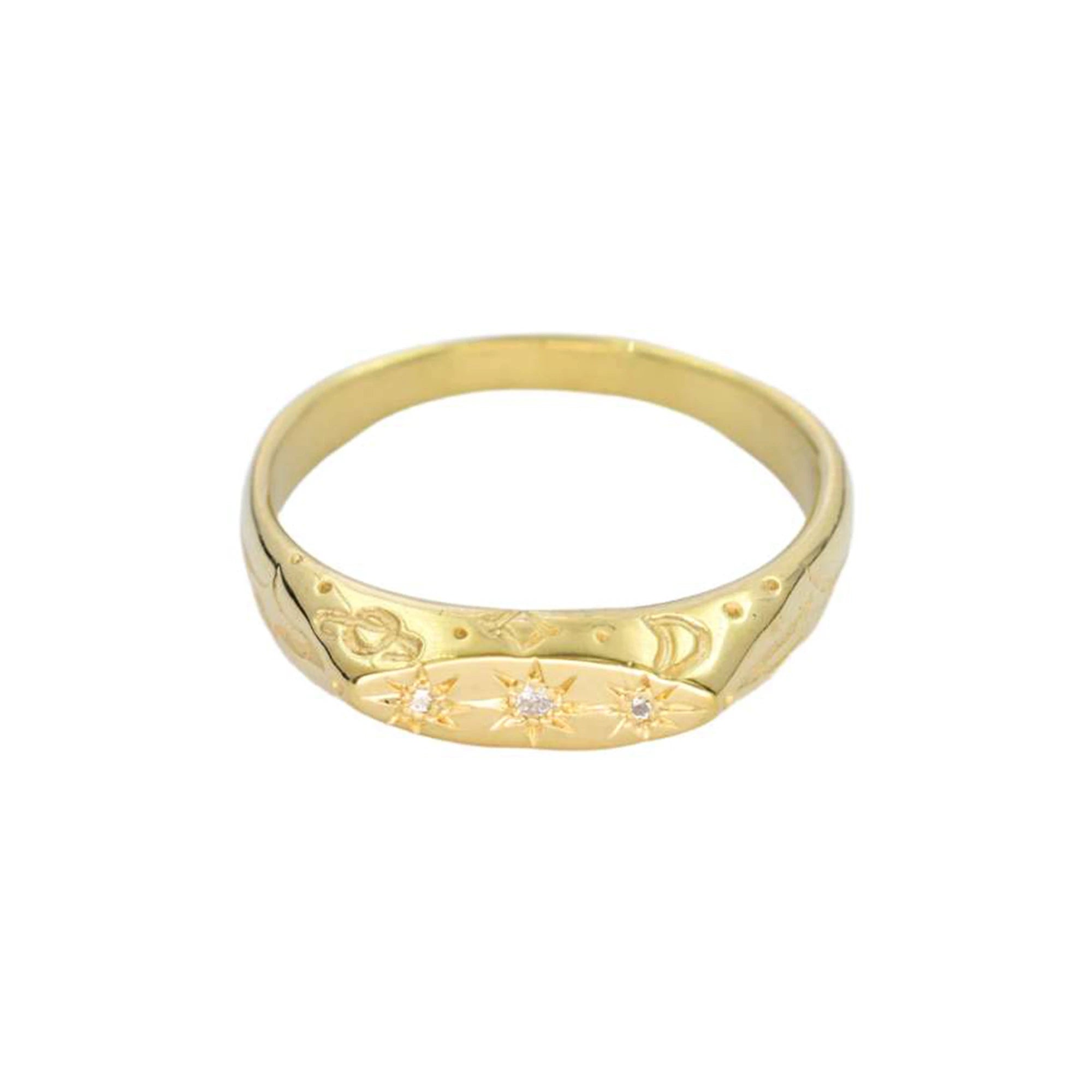 Gold ring with engraved design on a white background