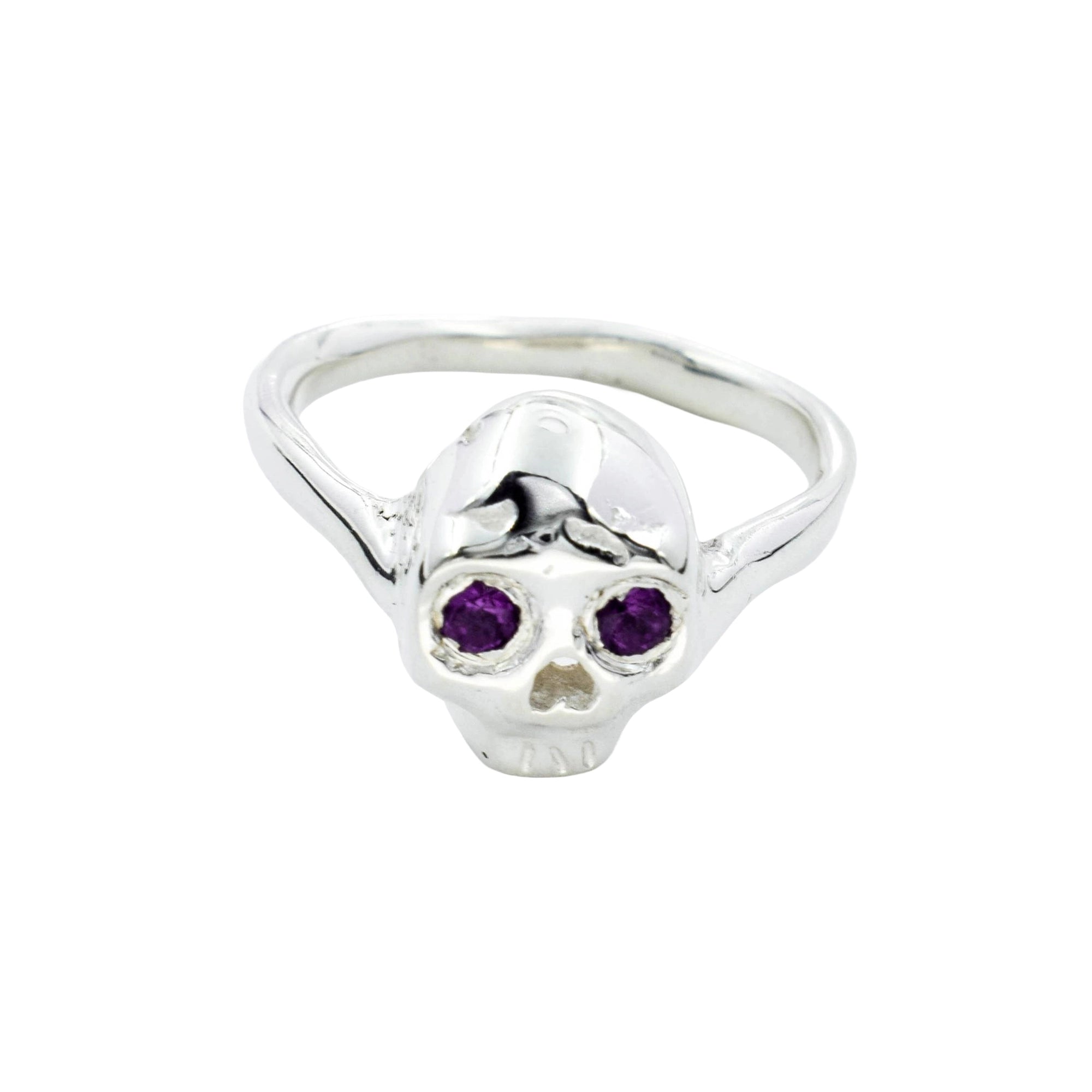 A sterling silver skull ring with purple gemstone eyes, shown on a plain white background.