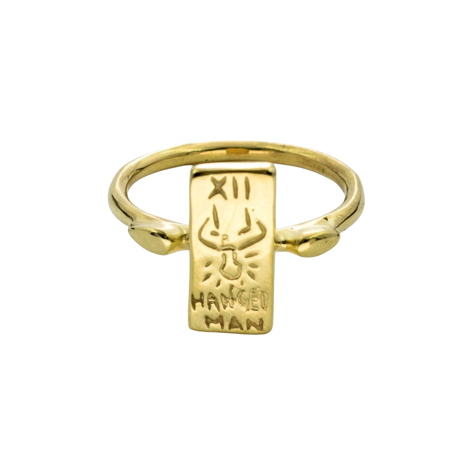 A gold-plated signet ring featuring a rectangular pendant engraved with a winged figure and the Roman numeral XII, with the words 'HANGED MAN' inscribed below.