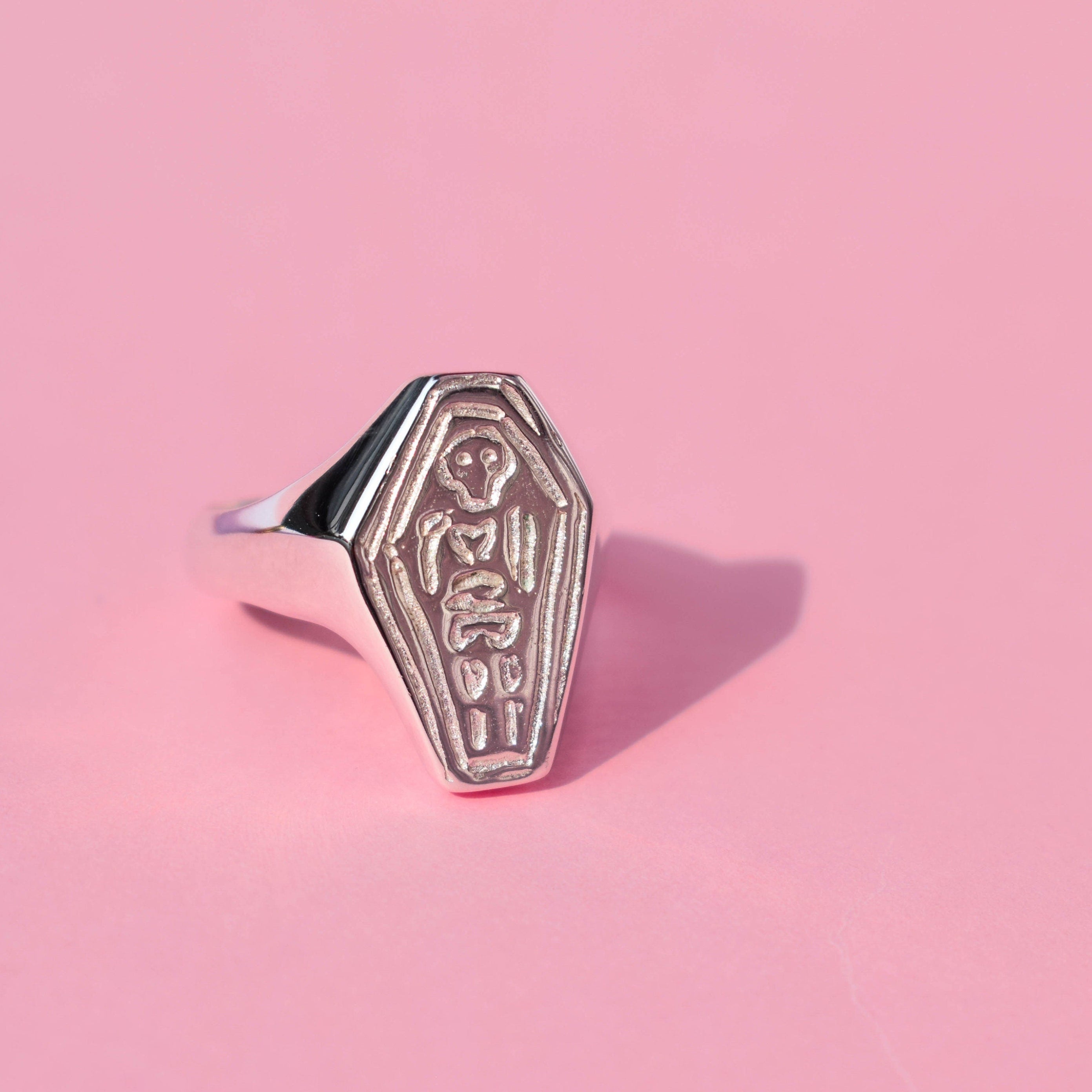 Coffin with skeleton signet ring