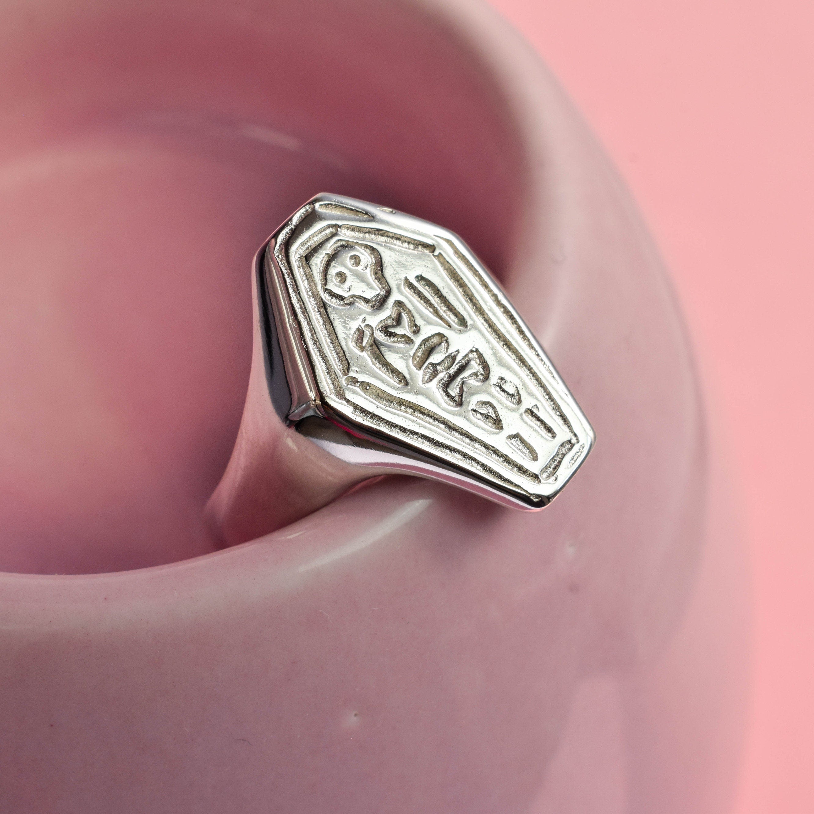 Coffin with skeleton signet ring