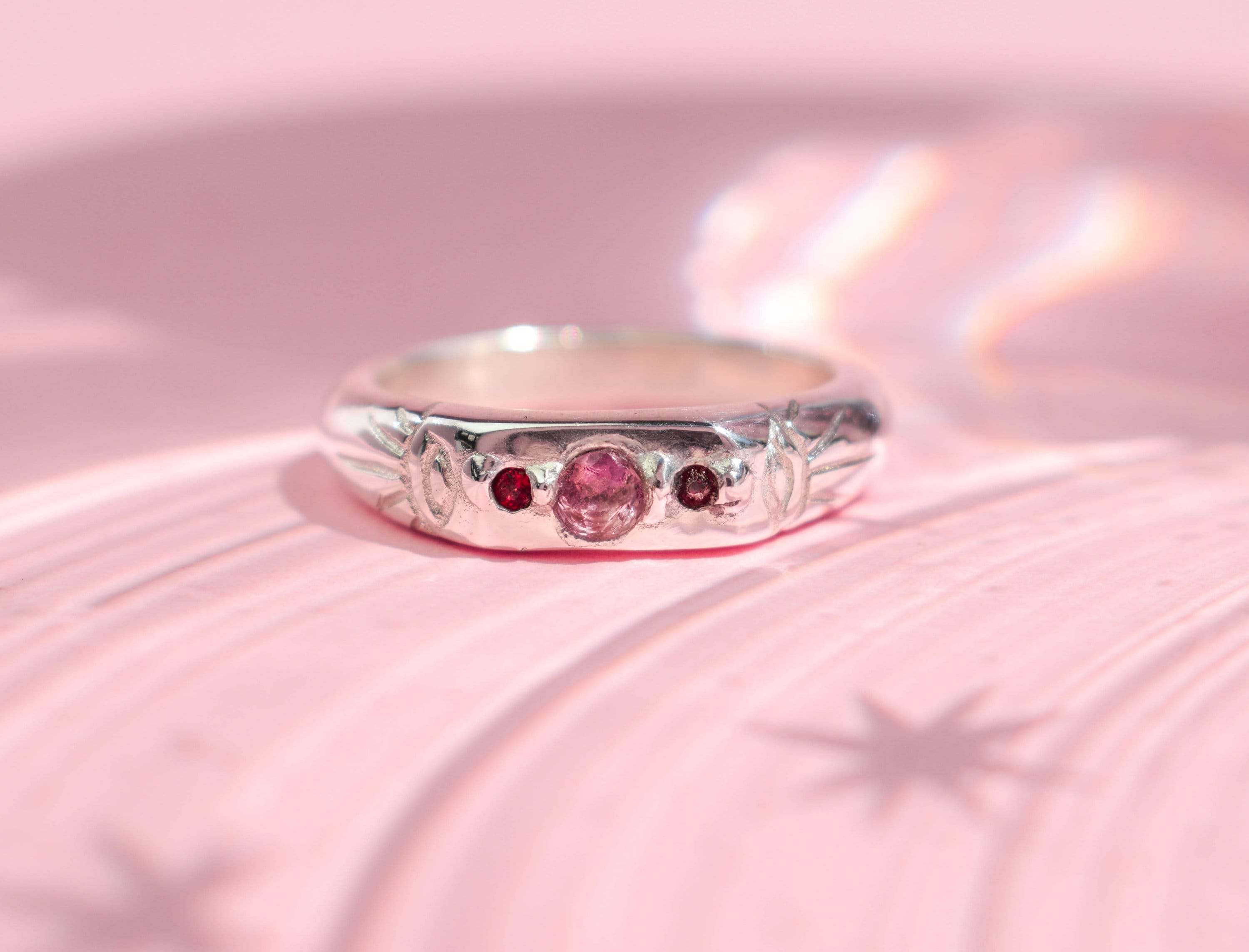 Pink tourmaline and red garnet band ring with two evil eyes