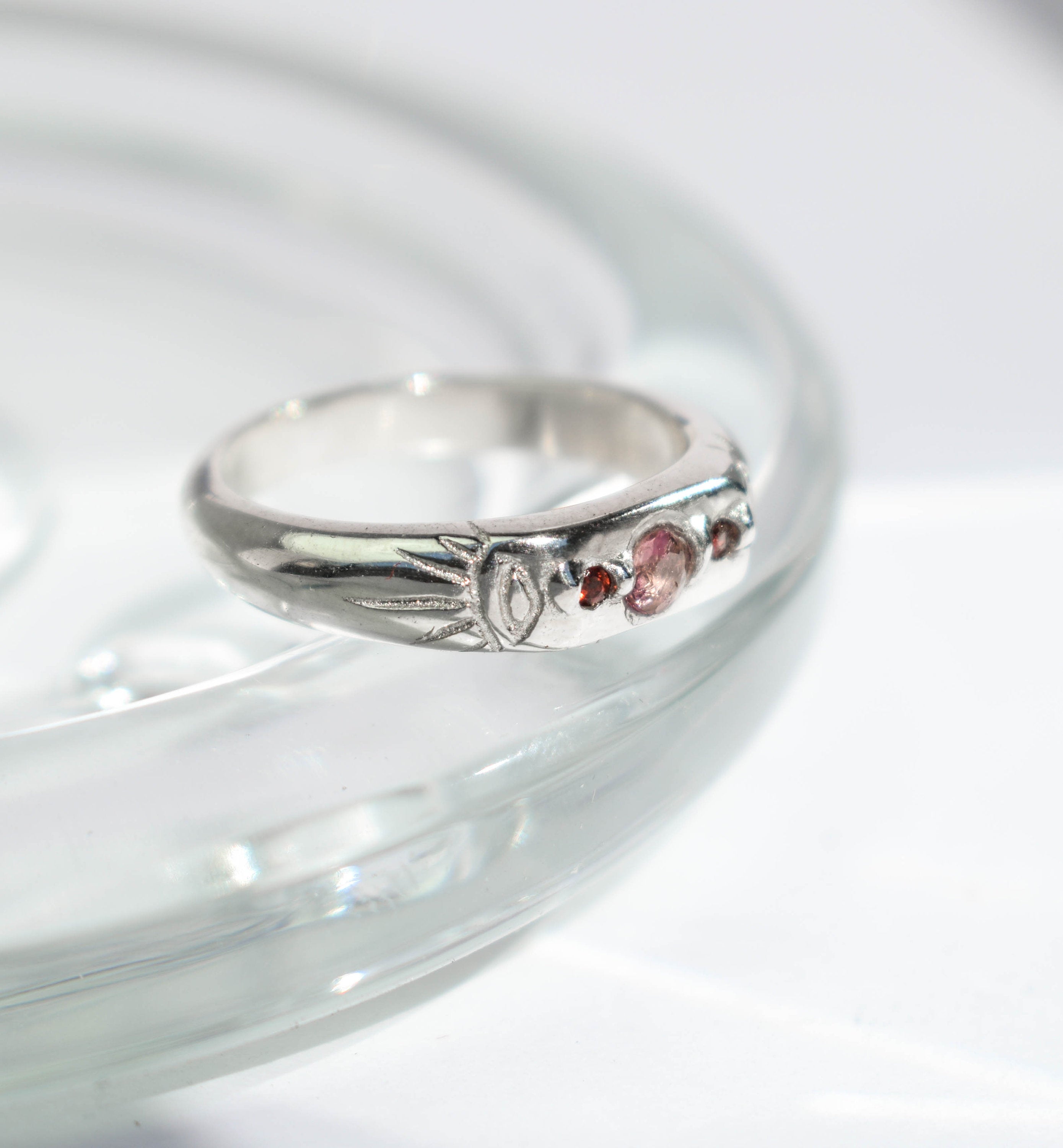 Pink tourmaline and red garnet band ring with two evil eyes