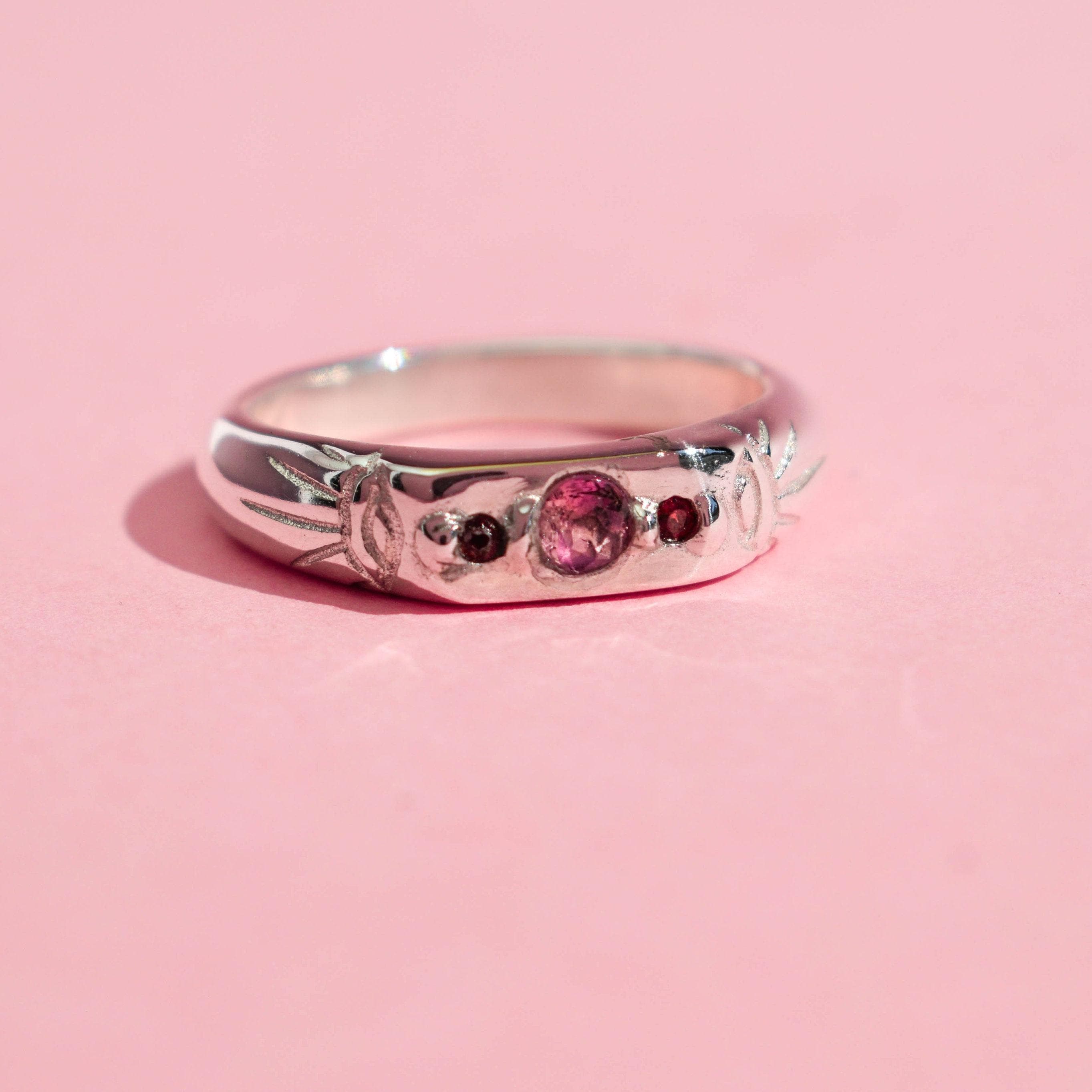 Pink tourmaline and red garnet band ring with two evil eyes