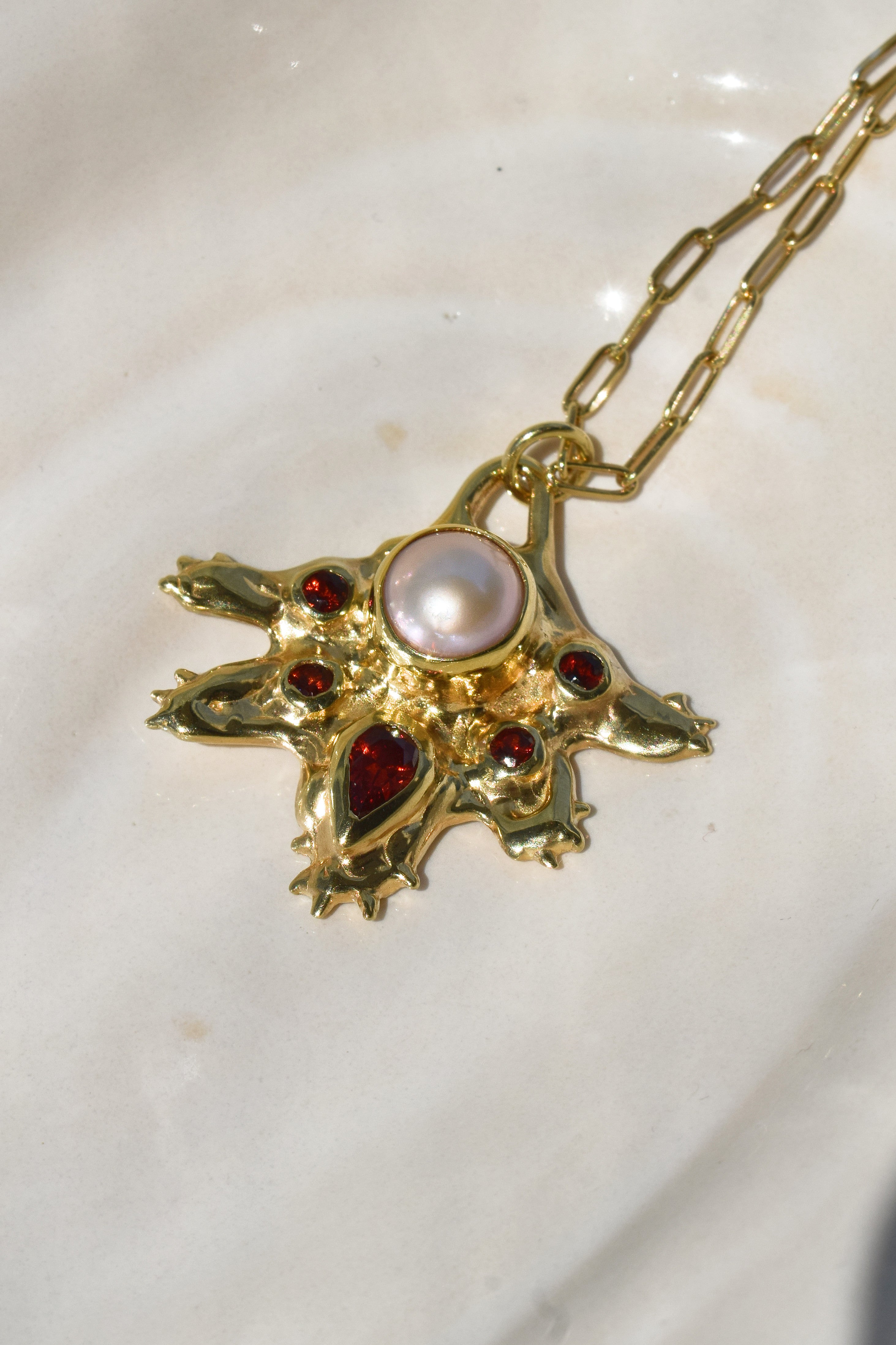 Coral inspired gold plated talisman necklace with pink pearl and red garnets