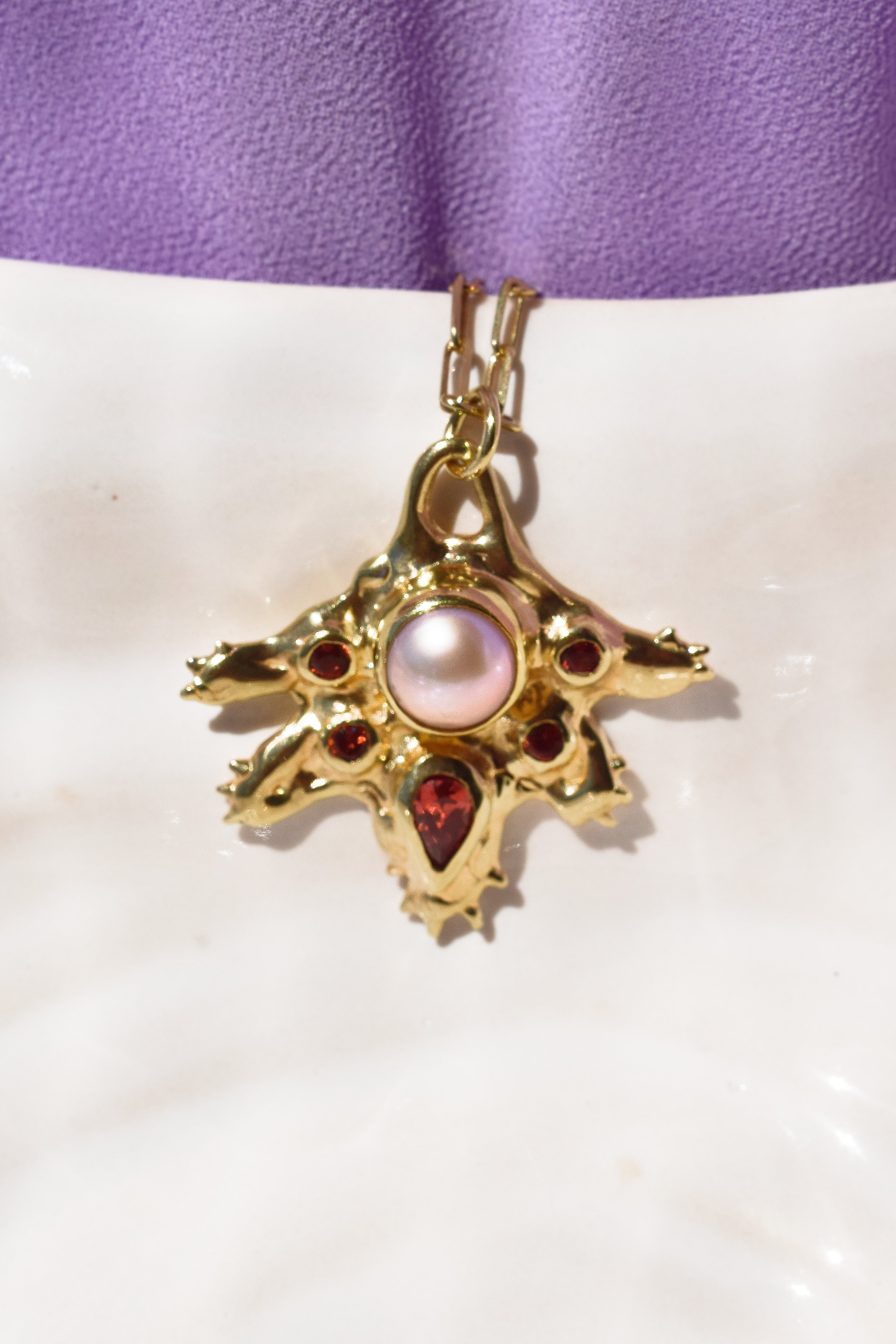 Coral inspired gold plated talisman necklace with pink pearl and red garnets