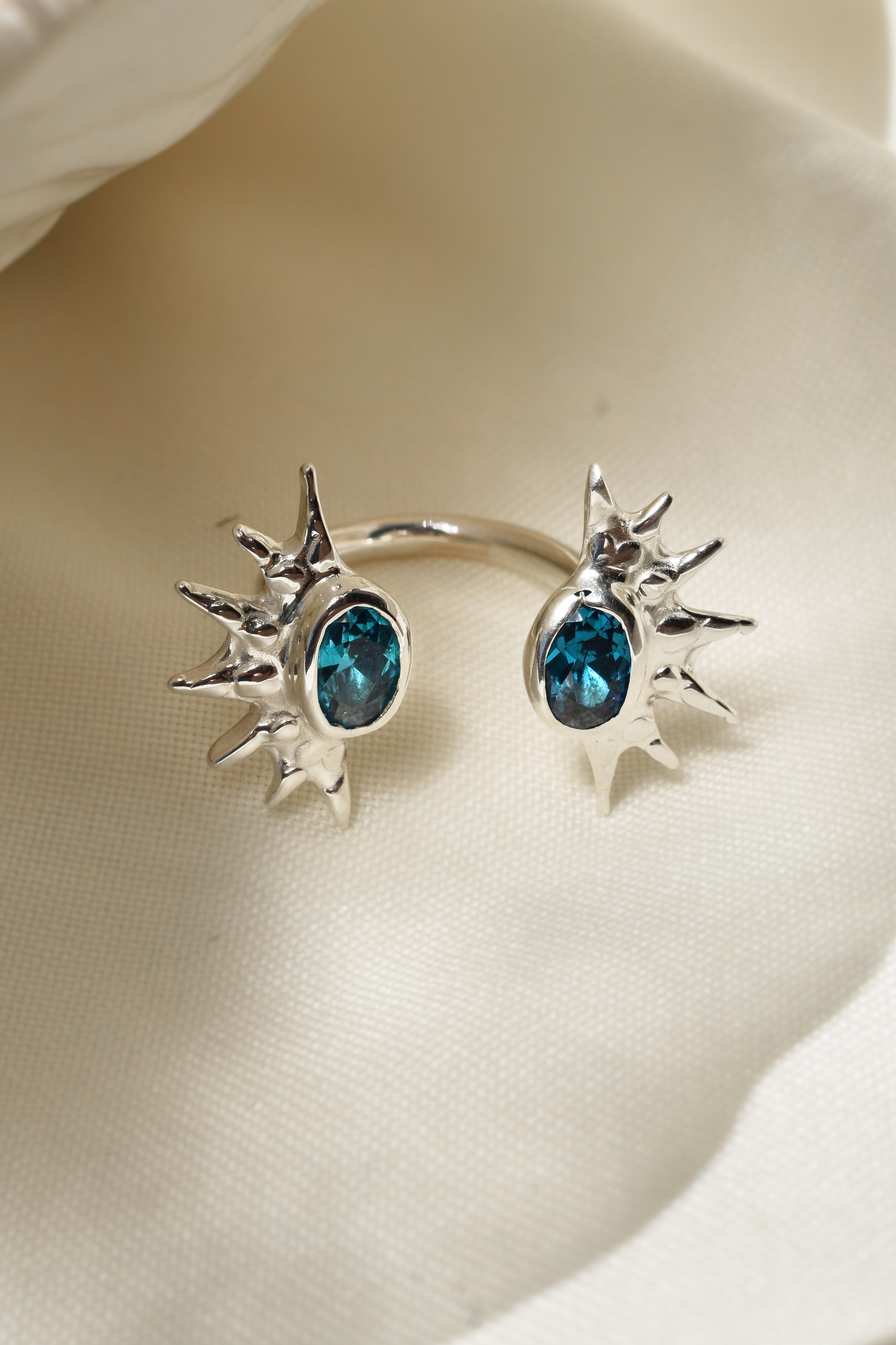 Double sunburst cuff ring with blue cz crystals