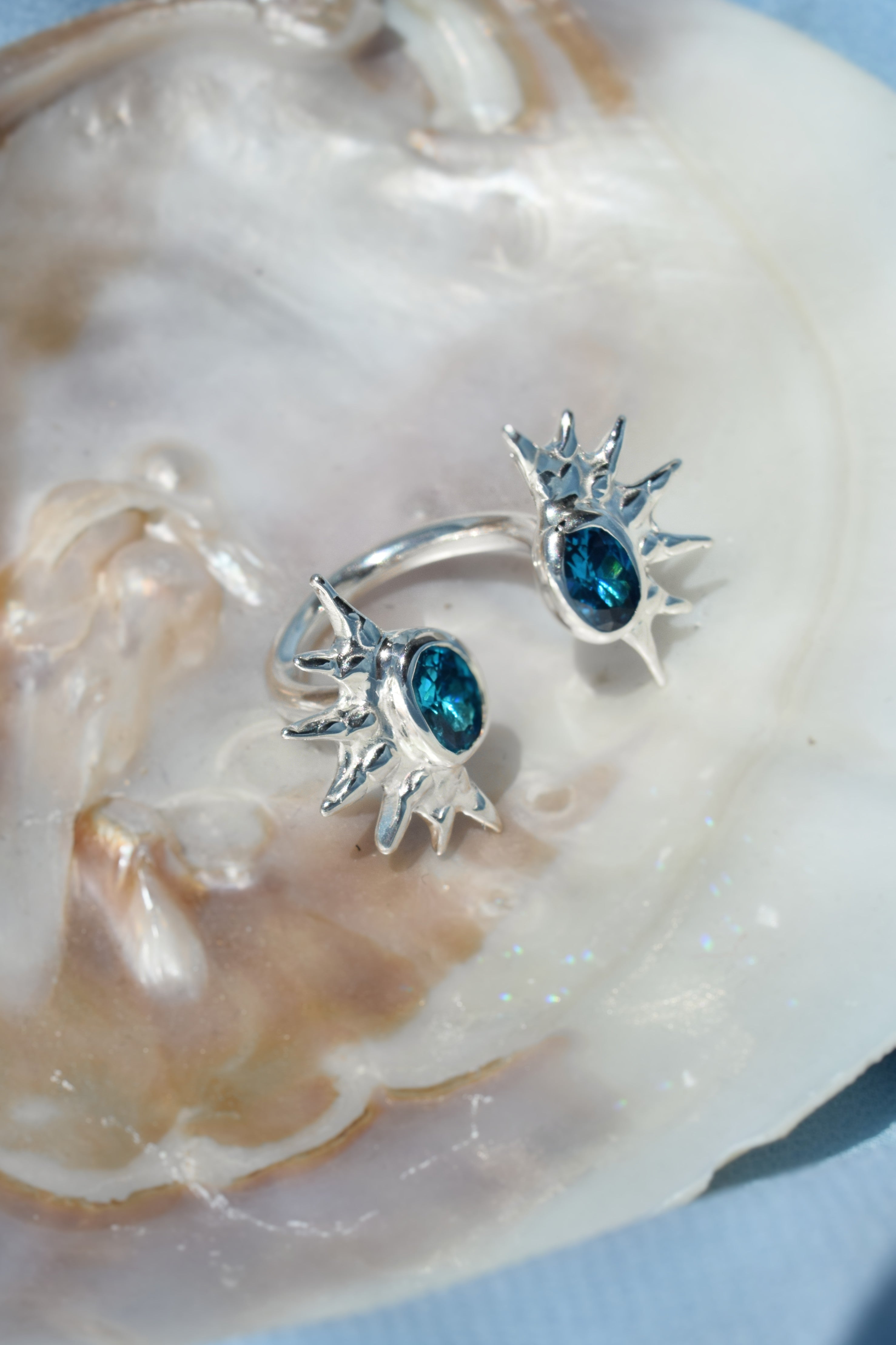 Double sunburst cuff ring with blue cz crystals