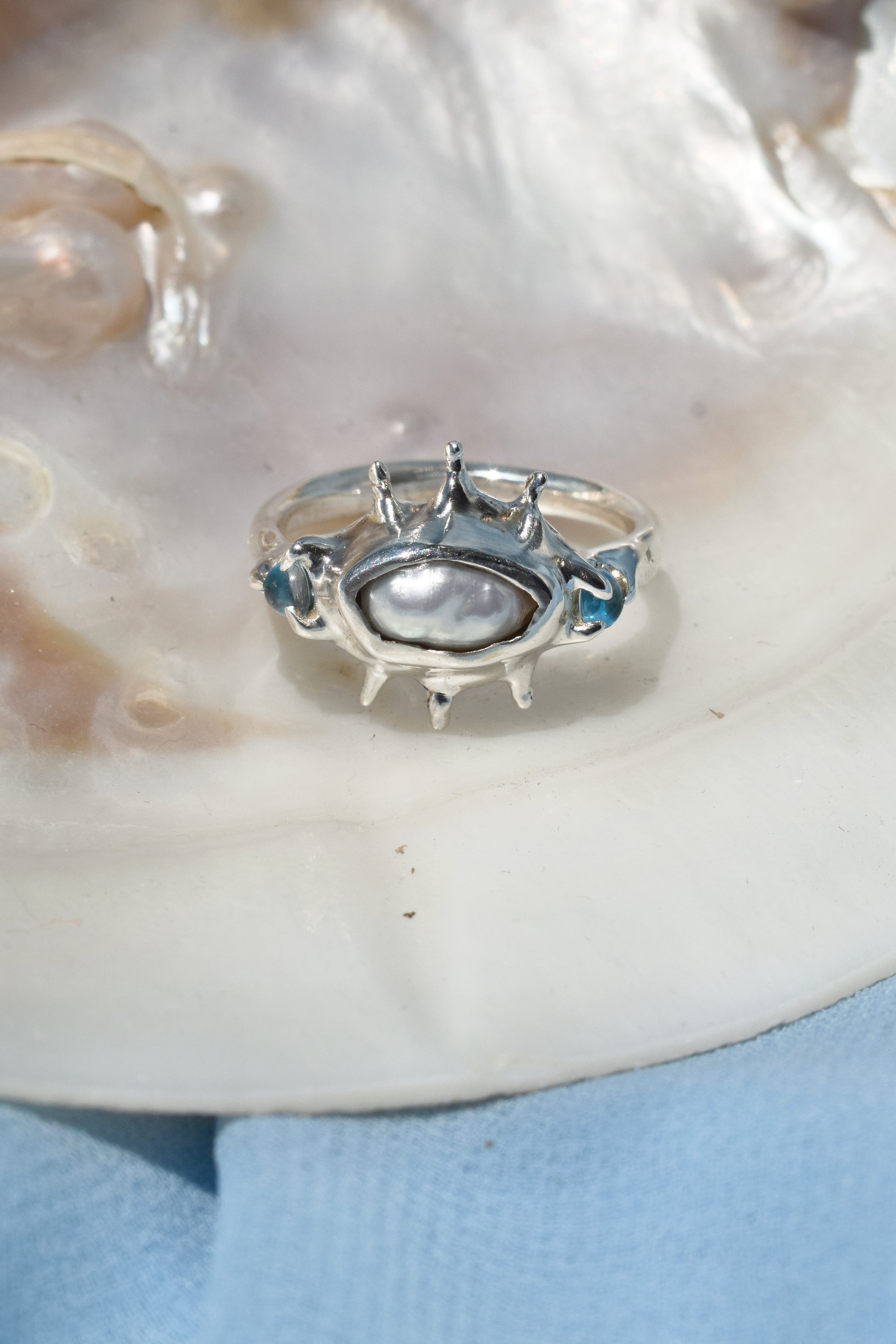 Ocean inspired ring with raw irregular pearl and blue topaz