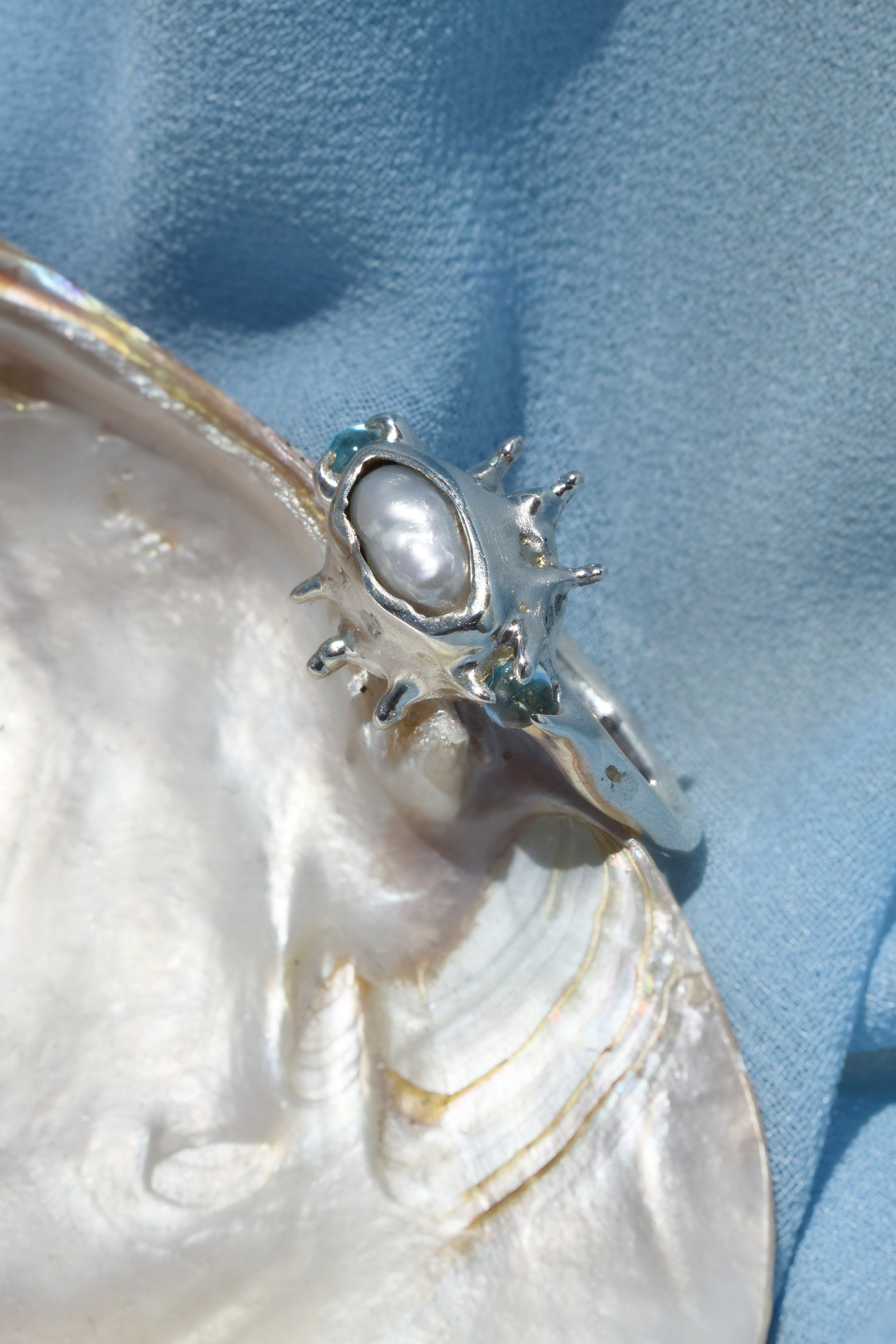 Ocean inspired ring with raw irregular pearl and blue topaz
