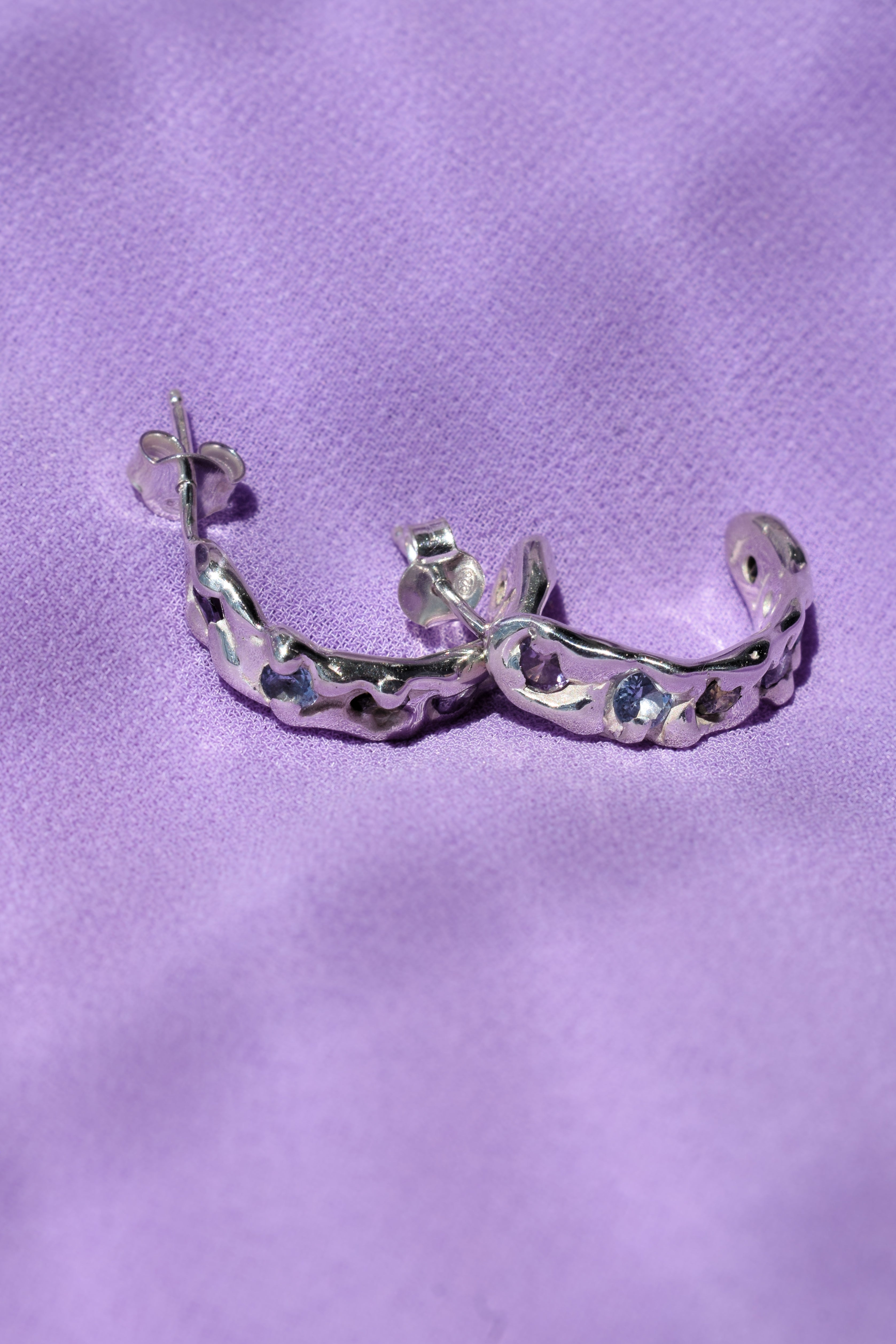 Molten textured sterling silver hoops earrings with purple, blue and olive green cz crystals