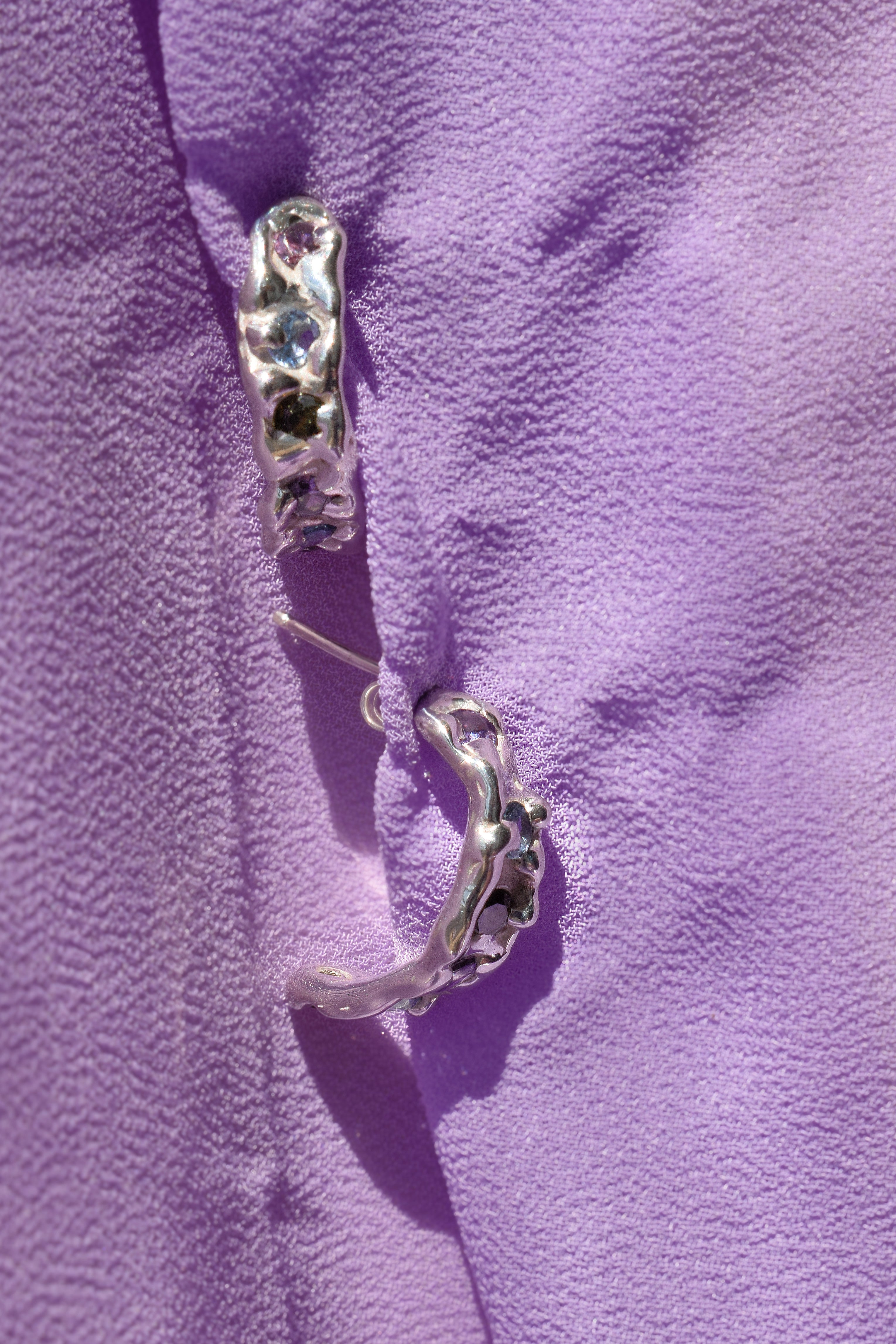 Molten textured sterling silver hoops earrings with purple, blue and olive green cz crystals