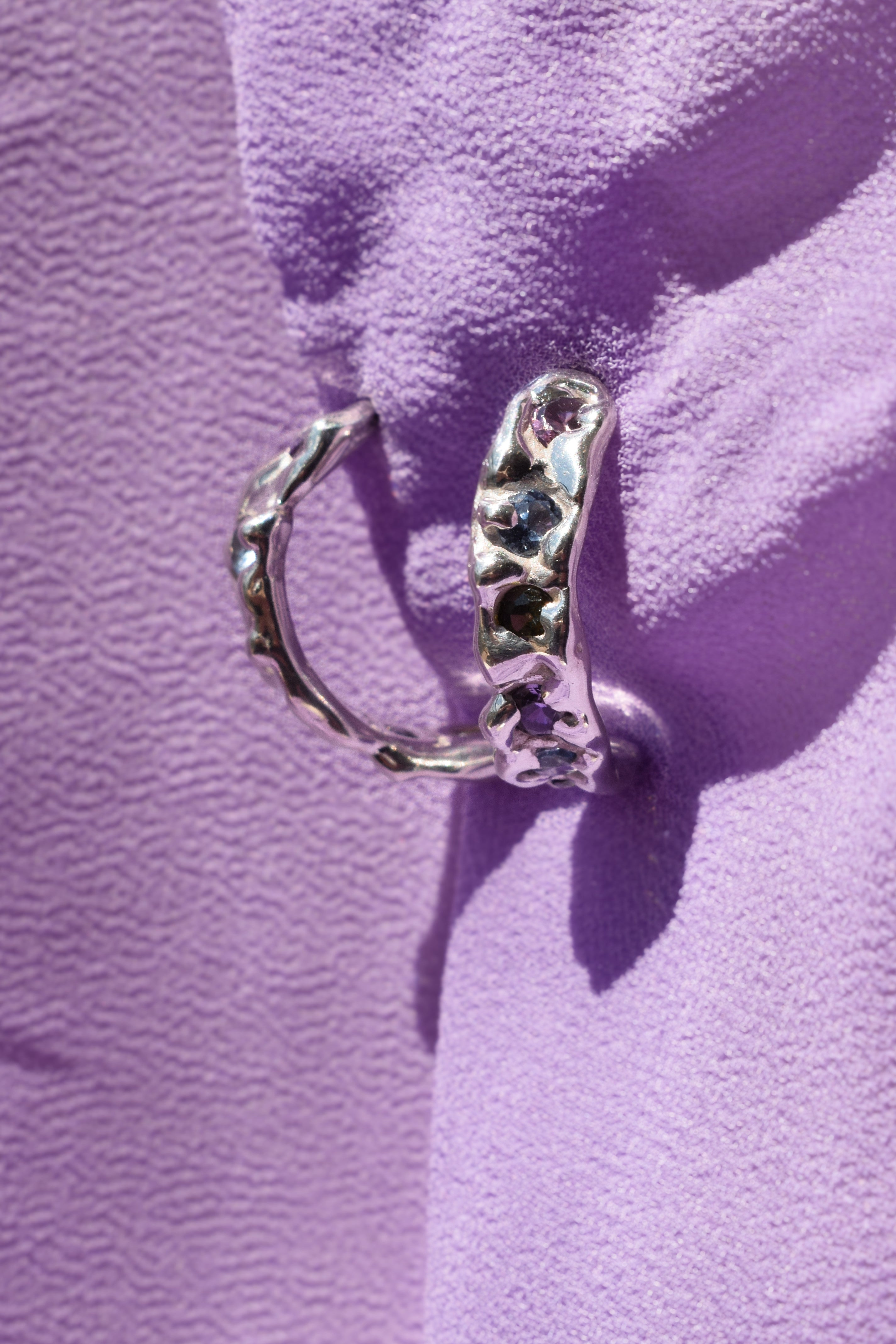 Molten textured sterling silver hoops earrings with purple, blue and olive green cz crystals