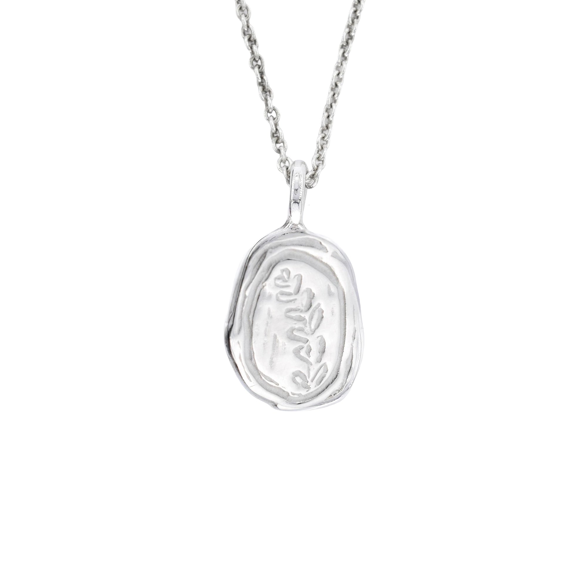A silver pendant necklace featuring an organic, irregularly shaped bezel setting with a textured, engraved floral motif in the center, suspended from a delicate silver chain against a solid white background.