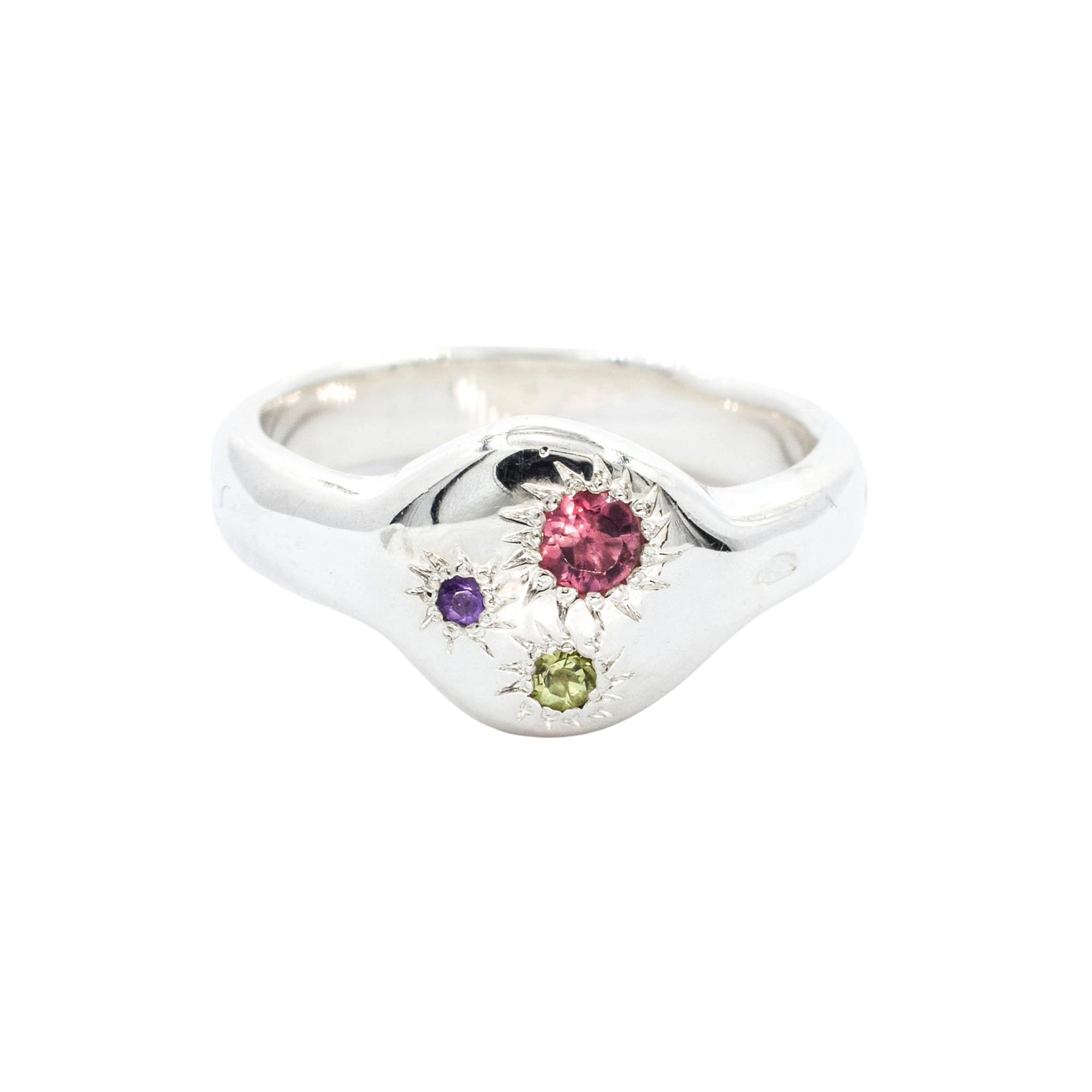 Silver ring with multicolored gemstones on a white background