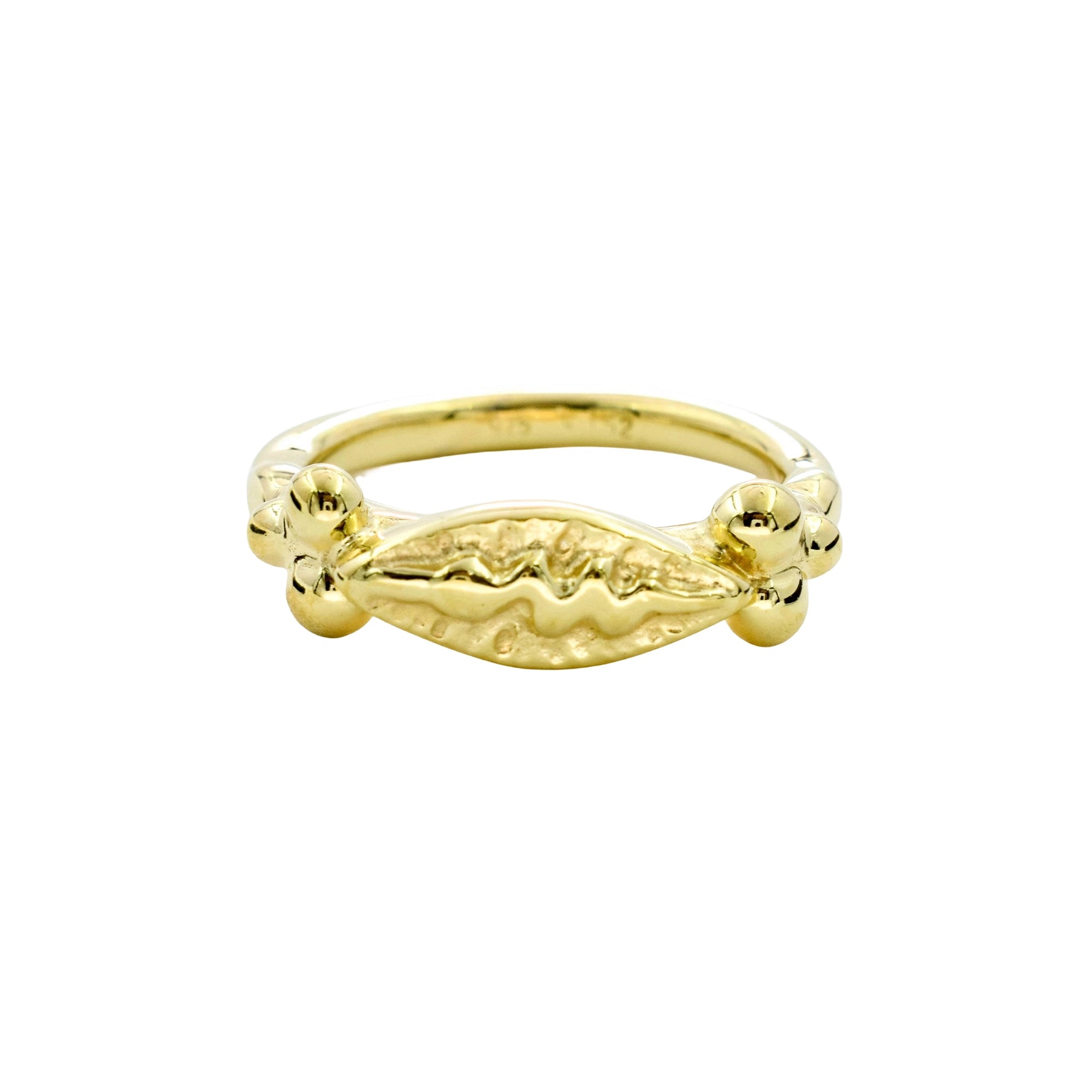 A gold ring with a textured, organic-shaped center and small raised details on the sides, shown against a plain white background.