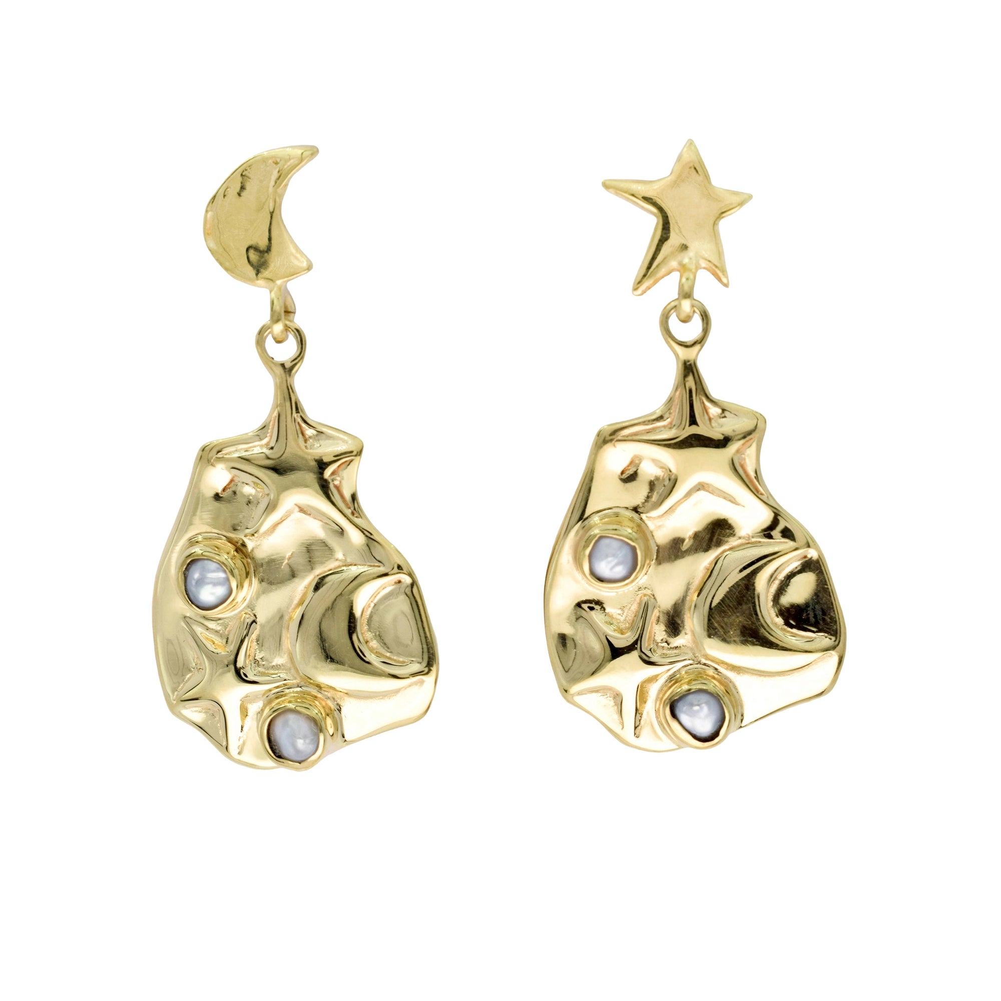 Gold earrings with star and moon designs on a white background