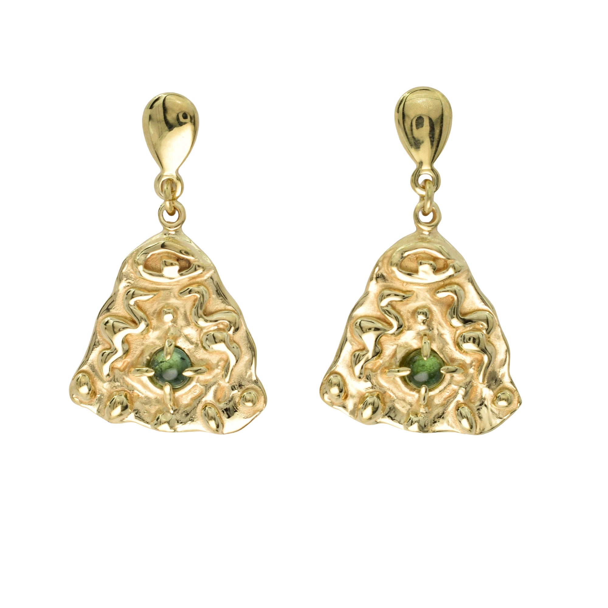 A pair of gold dangle earrings with an organic, textured abstract shape and a small green gemstone set in the center of each, shown against a plain white background.