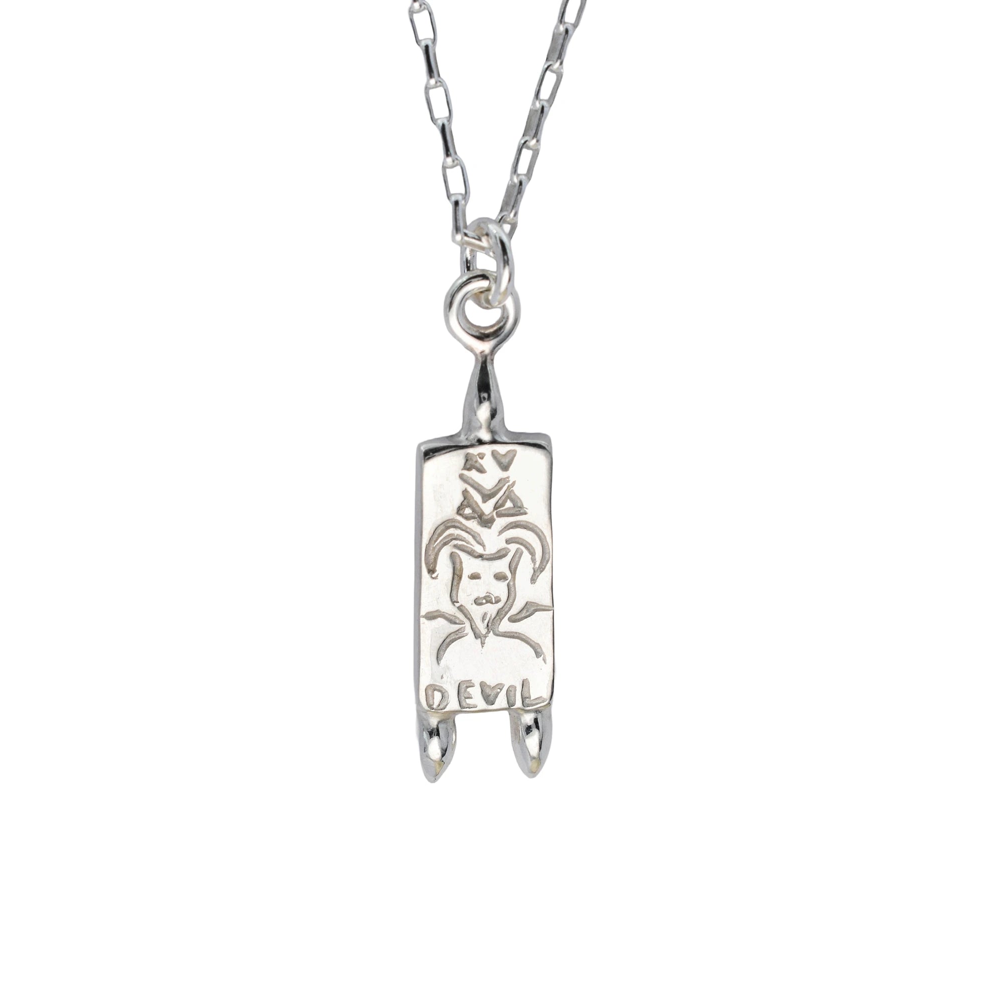 A silver pendant necklace featuring a vertical rectangular charm engraved with a goat head and the word 'DEVIL', suspended from a silver link chain against a plain white background.