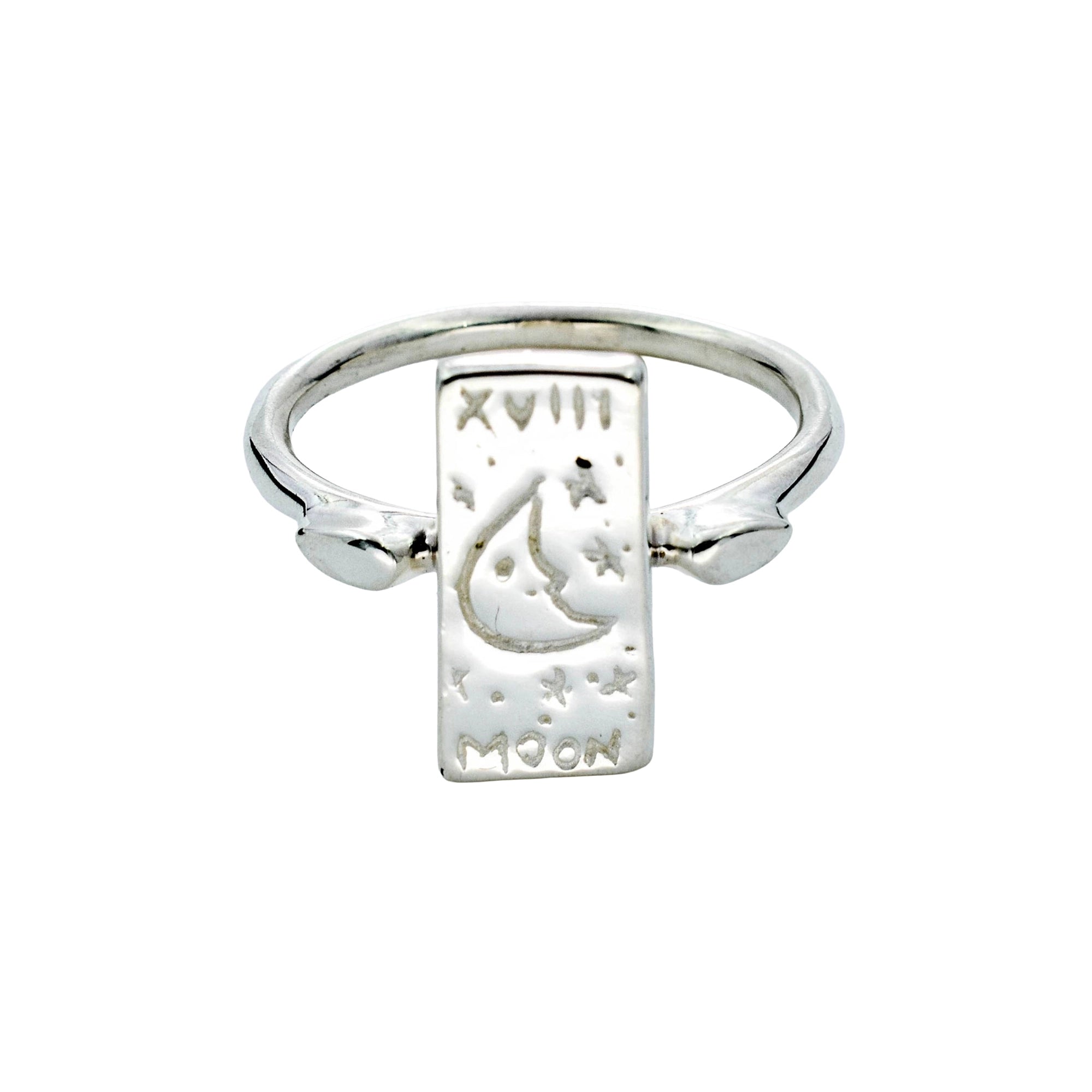 A sterling silver signet ring featuring a rectangular moon and star engraved plate on a polished band, shown against a plain white background.