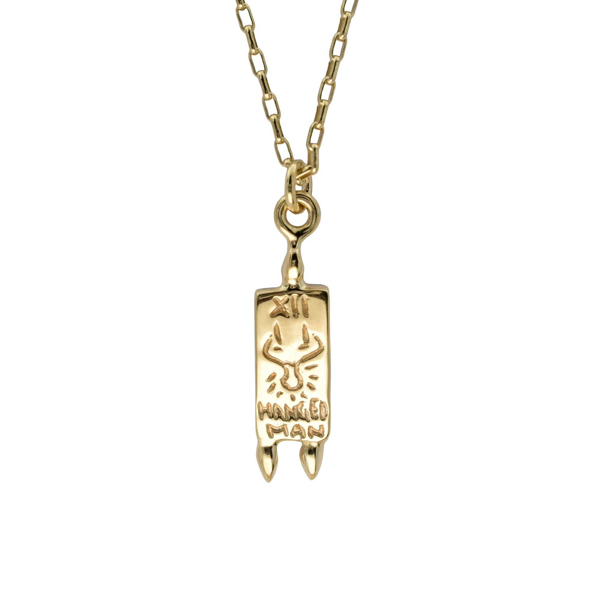 A gold chain necklace with a rectangular pendant featuring a stylized ram head and the engraved words 'HUNGED MAN', shown against a plain white background.