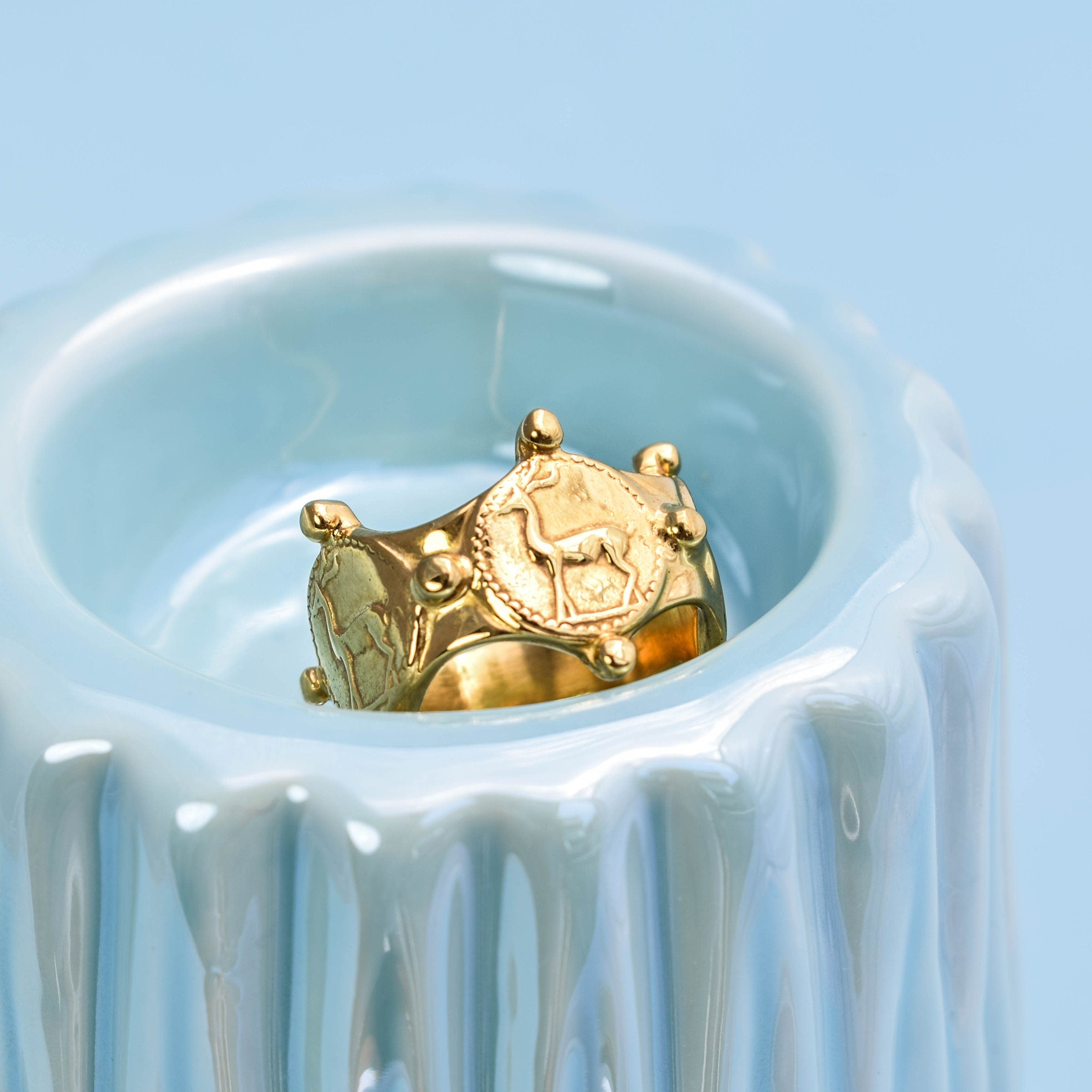 Wide gold tone deer ring