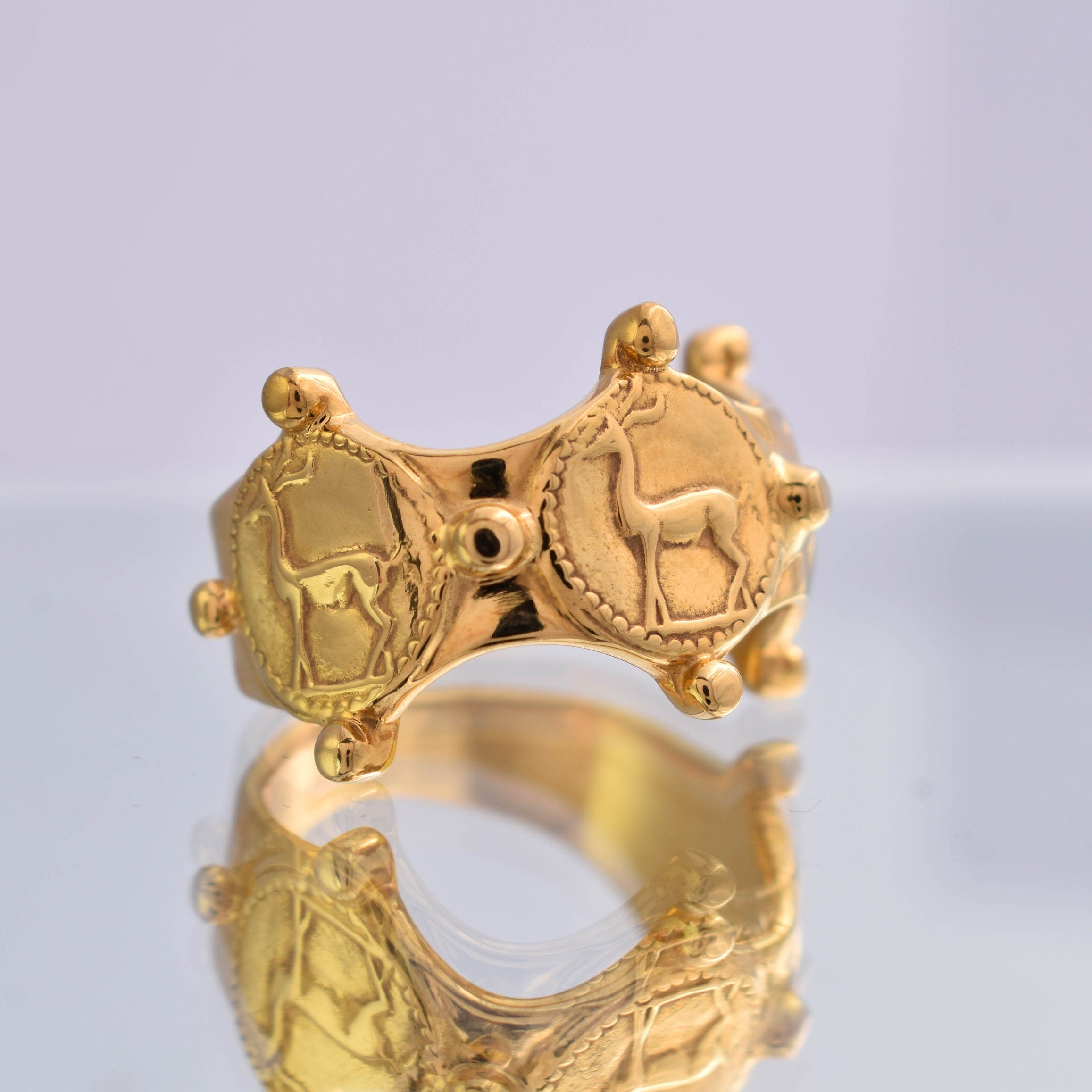 Wide gold tone deer ring