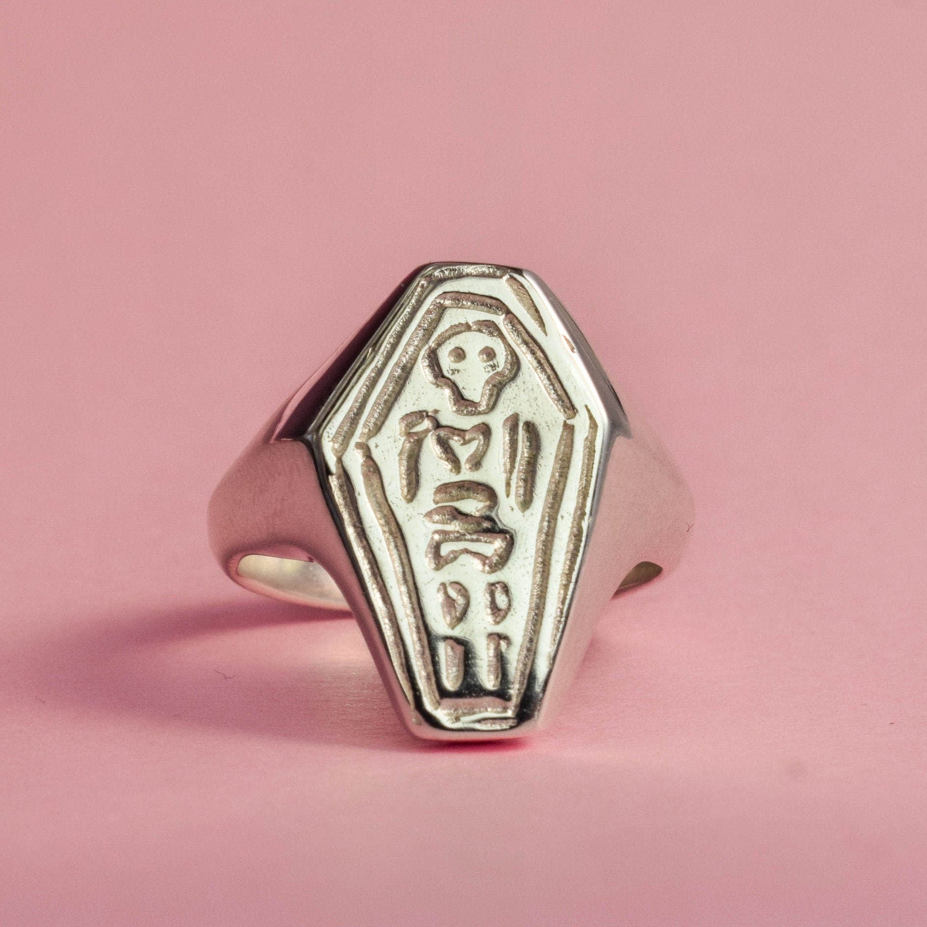 Coffin with skeleton signet ring