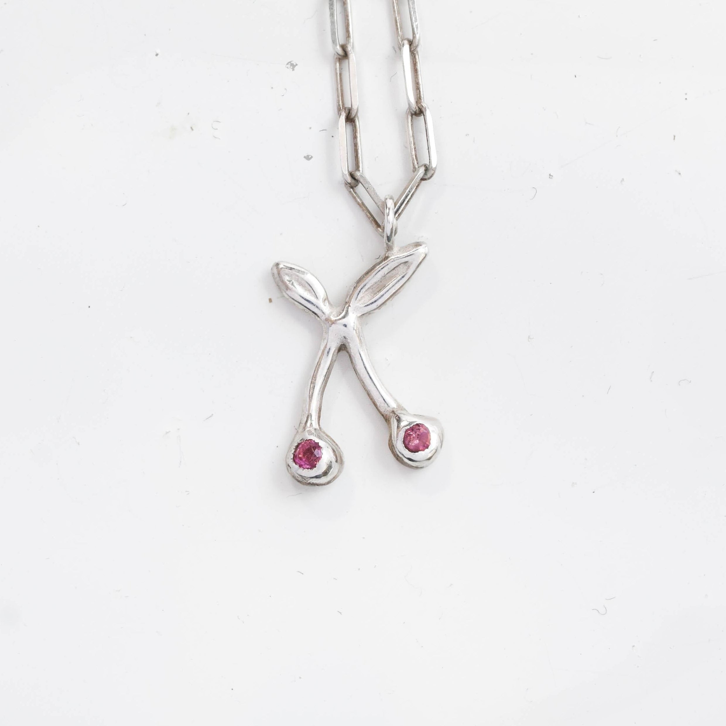 Silver necklace with a unique pendant on a white background